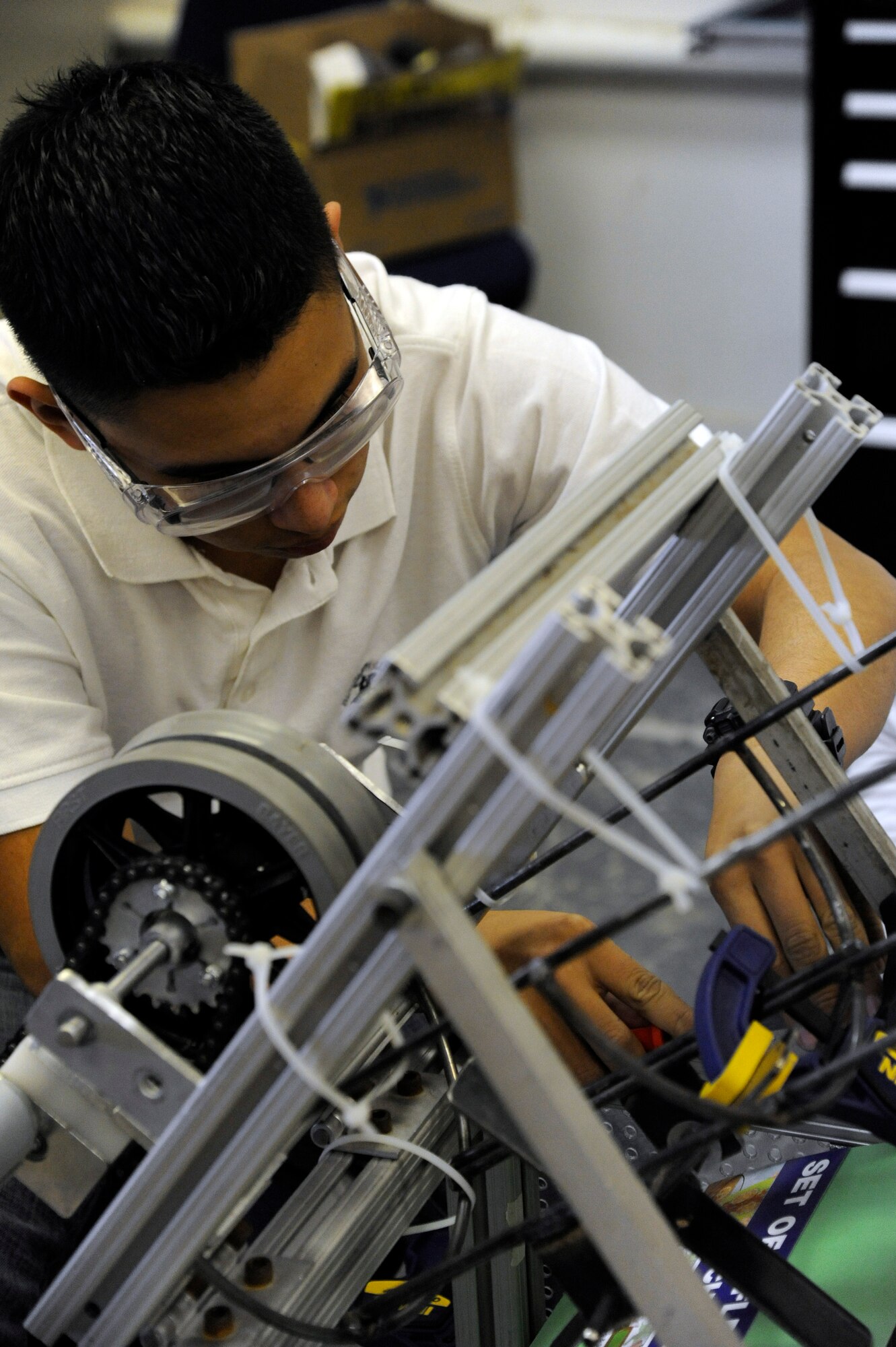 LAUGHLIN AIR FORCE BASE, Texas – A member of the Del Rio High School robotics team works on the robot’s basketball throwing system at the school’s engineering shop Feb. 14. For six weeks, the students planned and developed the robot to compete in the Rebound Rumble competition in San Antonio. (U.S. Air Force photo/Airman 1st Class Nathan L. Maysonet)