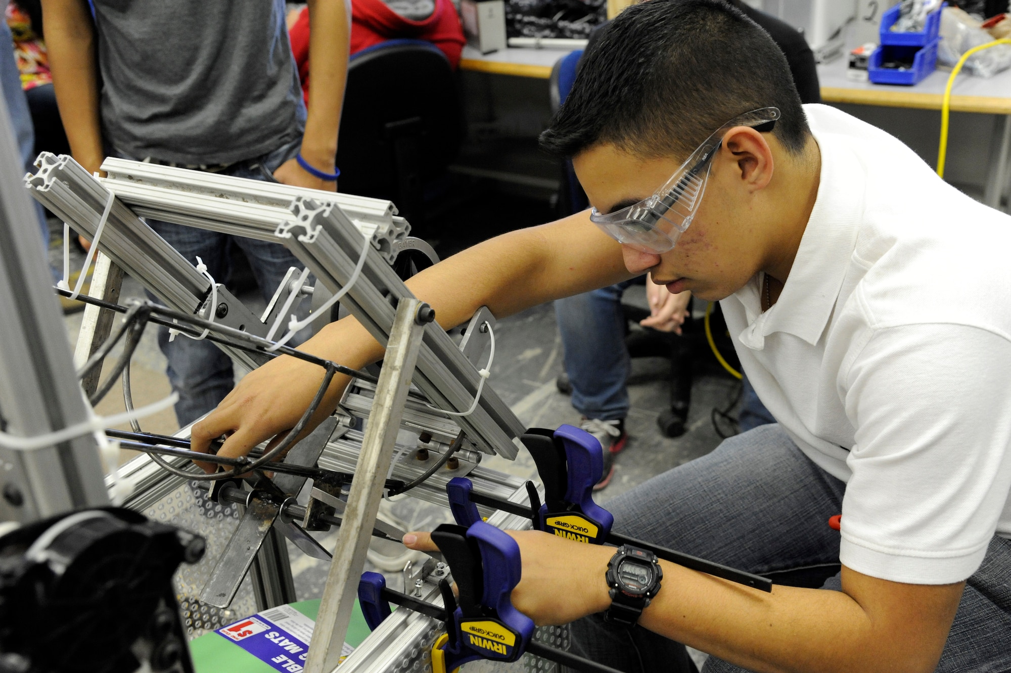 LAUGHLIN AIR FORCE BASE, Texas – A member of the Del Rio High School robotics team works on the robot’s basketball throwing system at the school’s engineering shop Feb. 14. For six weeks, the students planned and developed the robot to compete in the Rebound Rumble competition in San Antonio. (U.S. Air Force photo/Airman 1st Class Nathan L. Maysonet)