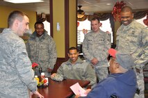 Airmen from the 916th Air Refueling Wing and 4th Fighter Wing visit with a veteran at the Durham VA Medical Facility on Feb. 14, 2012. Nearly 30 Airmen spent time handing out homemade cards from local schools and visiting with patients in the nursing facility, outpatient care and other areas of the hospital. (USAF photo by Maj. Shannon Mann, 916ARW/PA)