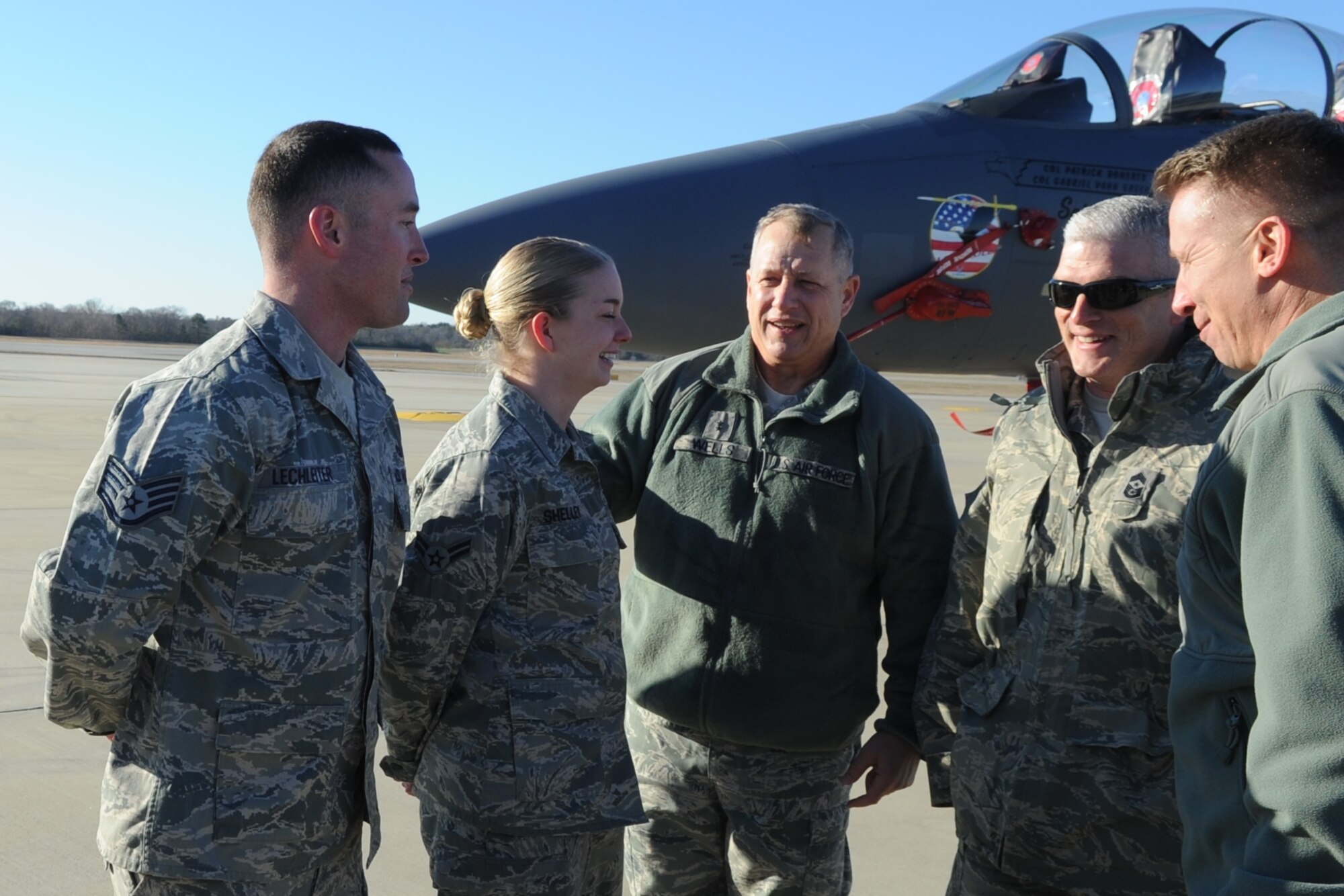 U.S. Air Force Maj. Gen. Lawrence Wells thanks U.S. Air Force Airman 1st Class Kasey Shelley and U.S. Air Force Staff Sgt. Travis Lechleiter for a job well done at Seymour Johnson Air Force Base, N.C., Jan. 13, 2012. Wells, 9th Air Force commander, oversaw a flagship competition here. During the competition flagship dedicated crew chiefs and their assistants were ranked on how aesthetically pleasing their aircraft was, aircraft forms, the ability to answer maintenance questions based on their skill levels and the Airmen’s appearance. The overall competition winners were Lechleiter and Shelly. Both Airmen are 333rd Aircraft Maintenance Unit crew chiefs. Shelly hails from Muncie, Ind. Lechleiter hails from Redding, Calif. (U.S. Air Force photo/Senior Airman Gino Reyes/Released)