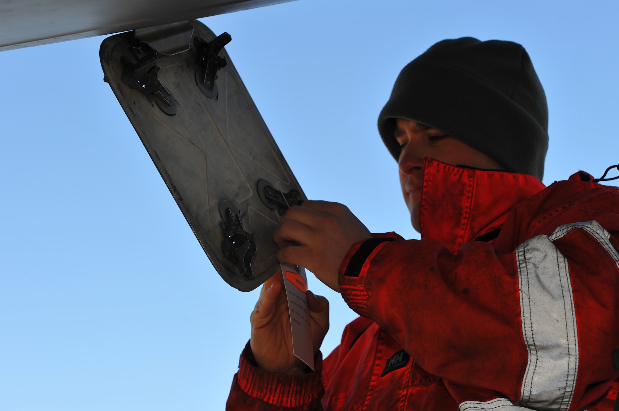 SPANGDAHLEM AIR BASE, Germany – Staff Sgt. Matthew Follin, 726th Air Mobility Squadron electrical environmental craftsman, tags a C-17 Globemaster III with an Air Force Form 1492 before fuel probe maintenance can begin here Feb. 10. The tag warns other maintainers that maintenance is in progress and the aircrafts batteries should not be reconnected until completed due to safety hazards. The AMS employs more than 100 Airmen to complete its three missions of aerial port, command and control and maintenance. These missions are essential to executing the mobilization of service members and cargo in support of operations in Europe and bases in U.S. Central Command. (U.S. Air Force photo by Airman 1st Class Dillon Davis/Released)
