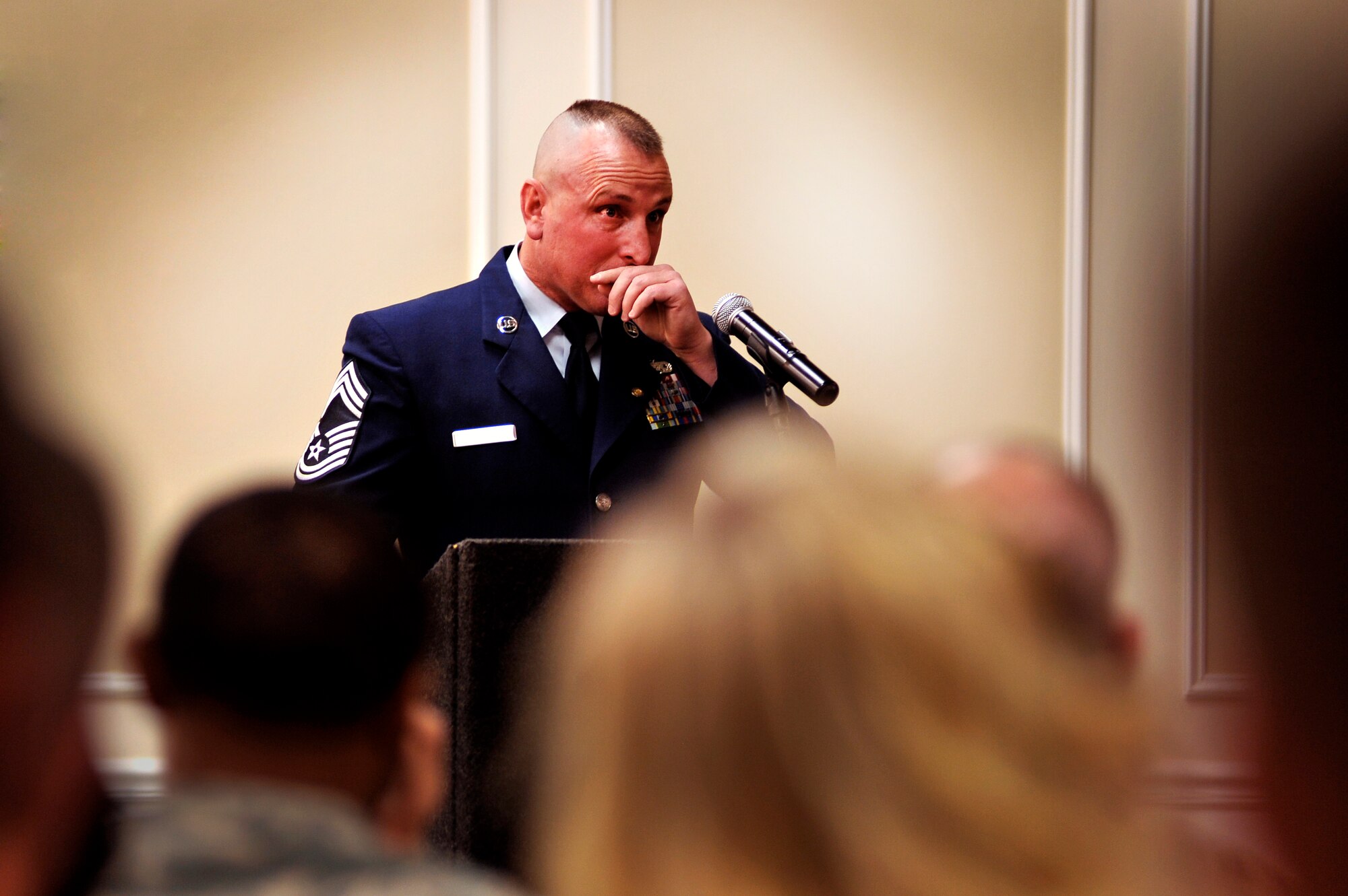 Chief Master Sgt. Patrick Porter fights back tears as he takes the podium to say a few words at the end of his official retirement ceremony, Feb. 14, 2012, Shaw Air Force Base, S.C. Several Airmen and civilian members of Team Shaw filled the Carolina Skies club to support Porter as he closed a vast and important chapter in his life. According to Porter's superiors, mentees, and peers he was best known for sharing his immense military wisdom gained over his 25 plus years of service as well as his straight forward and unique leadership style. (U.S. Air Force photo by Senior Airman Kenny Holston/Released) 

