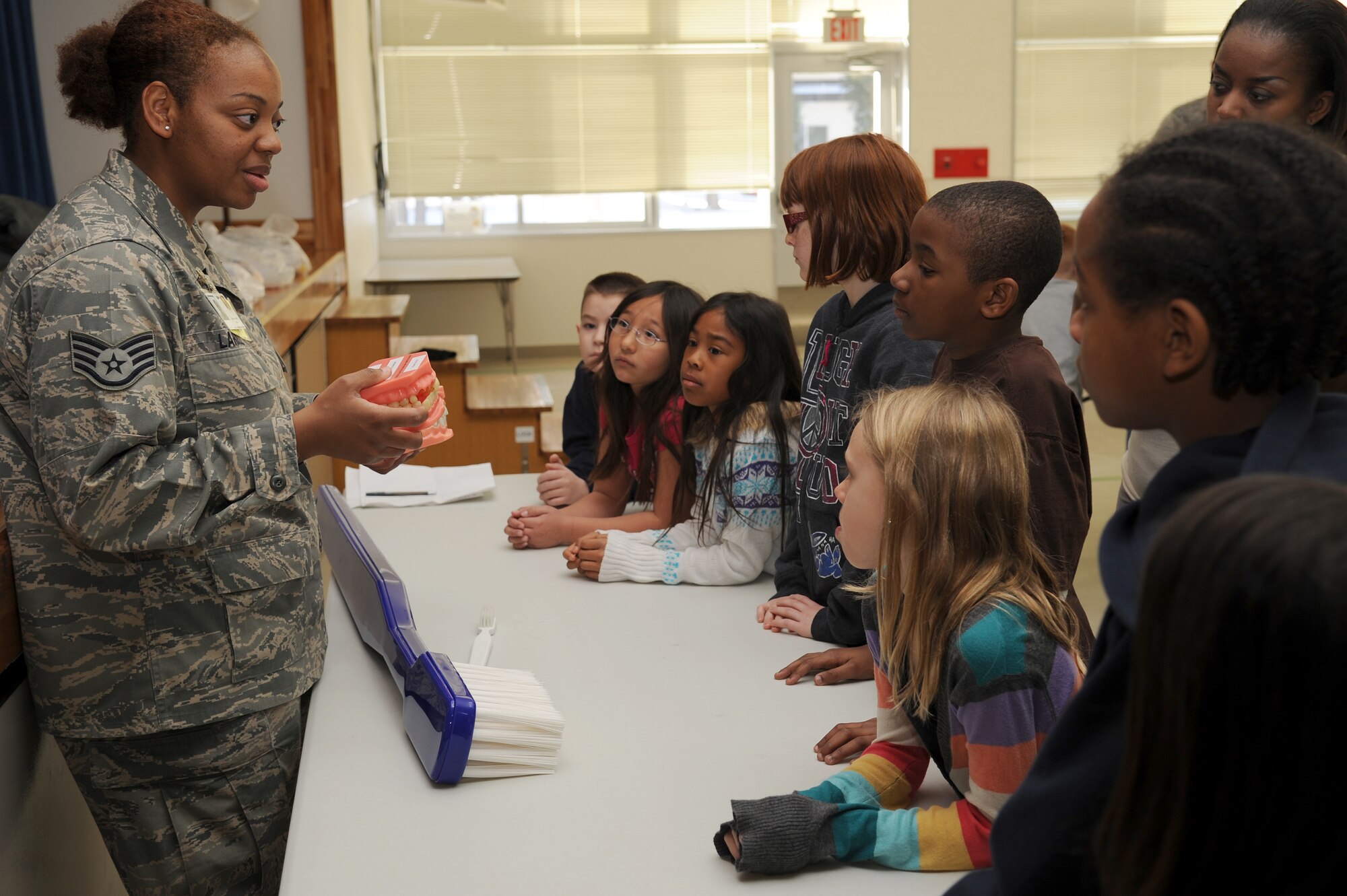 U.S. Air Force Staff Sgt. Tamika Lardell, 35th Dental Squadron NCO in charge of preventive dentistry, talks to third grade students at Sollars Elementary School about the importance of brushing and flossing their teeth during a Children's Dental Health Month presentation at Misawa Air Base, Japan Feb. 16, 2012. National Children's Dental Health Month began as a one-day event in Cleveland, Ohio. on Feb. 3, 1941 and the American Dental Association held the first national observance of Children's Dental Health Day on Feb. 8, 1949. This single day of observance became a week-long event in 1955, and in 1981, the program was extended to a month-long celebration known today as National Children's Dental Health Month. (U.S. Air Force photo by Tech. Sgt. Marie Brown/Released)
