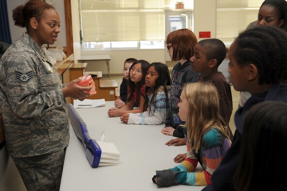 U.S. Air Force Staff Sgt. Tamika Lardell, 35th Dental Squadron NCO in charge of preventive dentistry, talks to third grade students at Sollars Elementary School about the importance of brushing and flossing their teeth during a Children's Dental Health Month presentation at Misawa Air Base, Japan Feb. 16, 2012. National Children's Dental Health Month began as a one-day event in Cleveland, Ohio. on Feb. 3, 1941 and the American Dental Association held the first national observance of Children's Dental Health Day on Feb. 8, 1949. This single day of observance became a week-long event in 1955, and in 1981, the program was extended to a month-long celebration known today as National Children's Dental Health Month. (U.S. Air Force photo by Tech. Sgt. Marie Brown/Released)