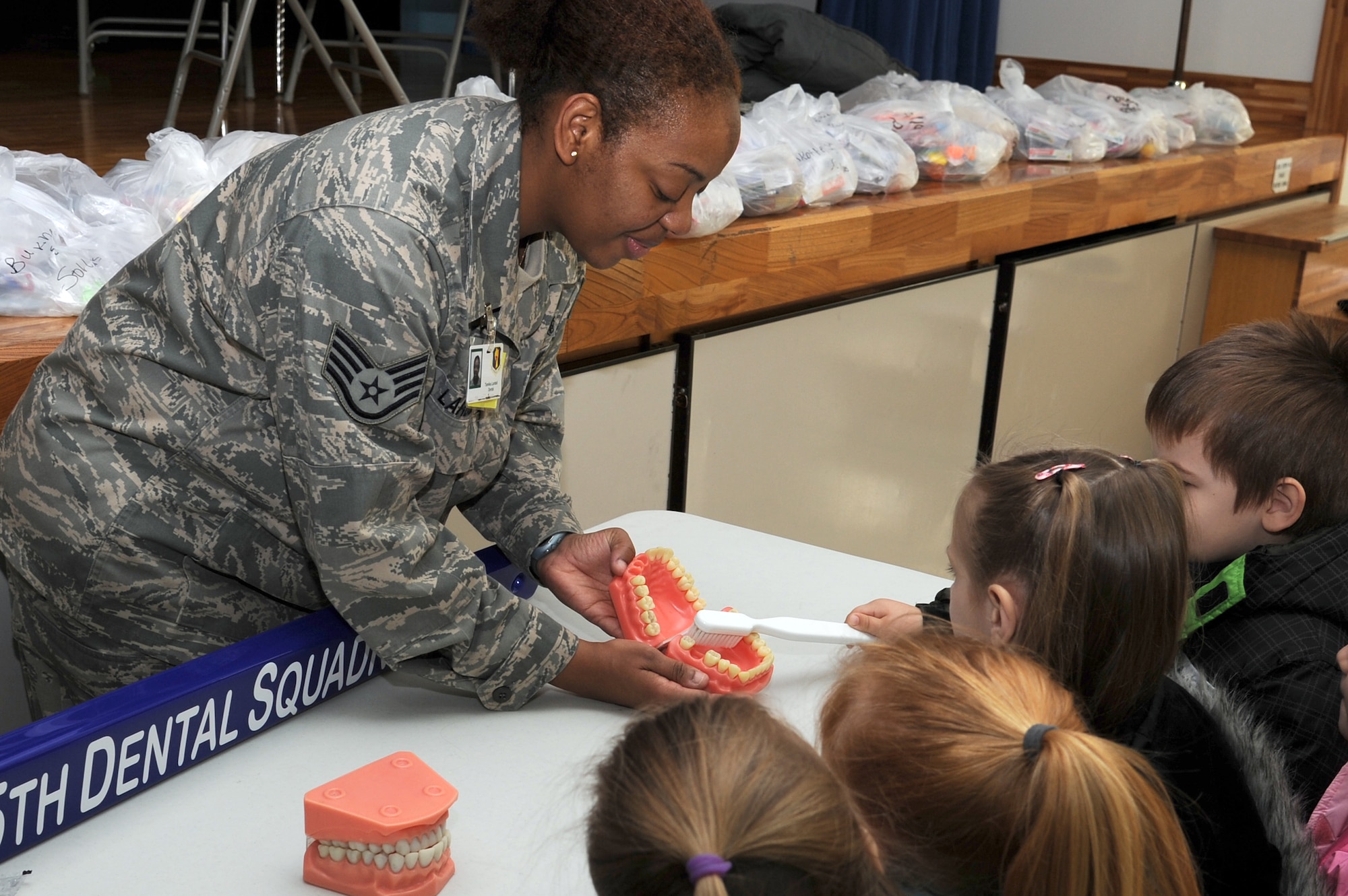 U.S. Air Force Staff Sgt. Tamika Lardell, 35th Dental Squadron NCO in charge of preventive dentistry, teaches Sure Start students at Sollars Elementary School how to brush their teeth during a National Children's Dental Health Month presentation at Misawa Air Base, Japan Feb. 16, 2012. Children can be seen at the dentist as soon as their first tooth emerges. (U.S. Air Force photo by Tech. Sgt. Marie Brown/Released)
