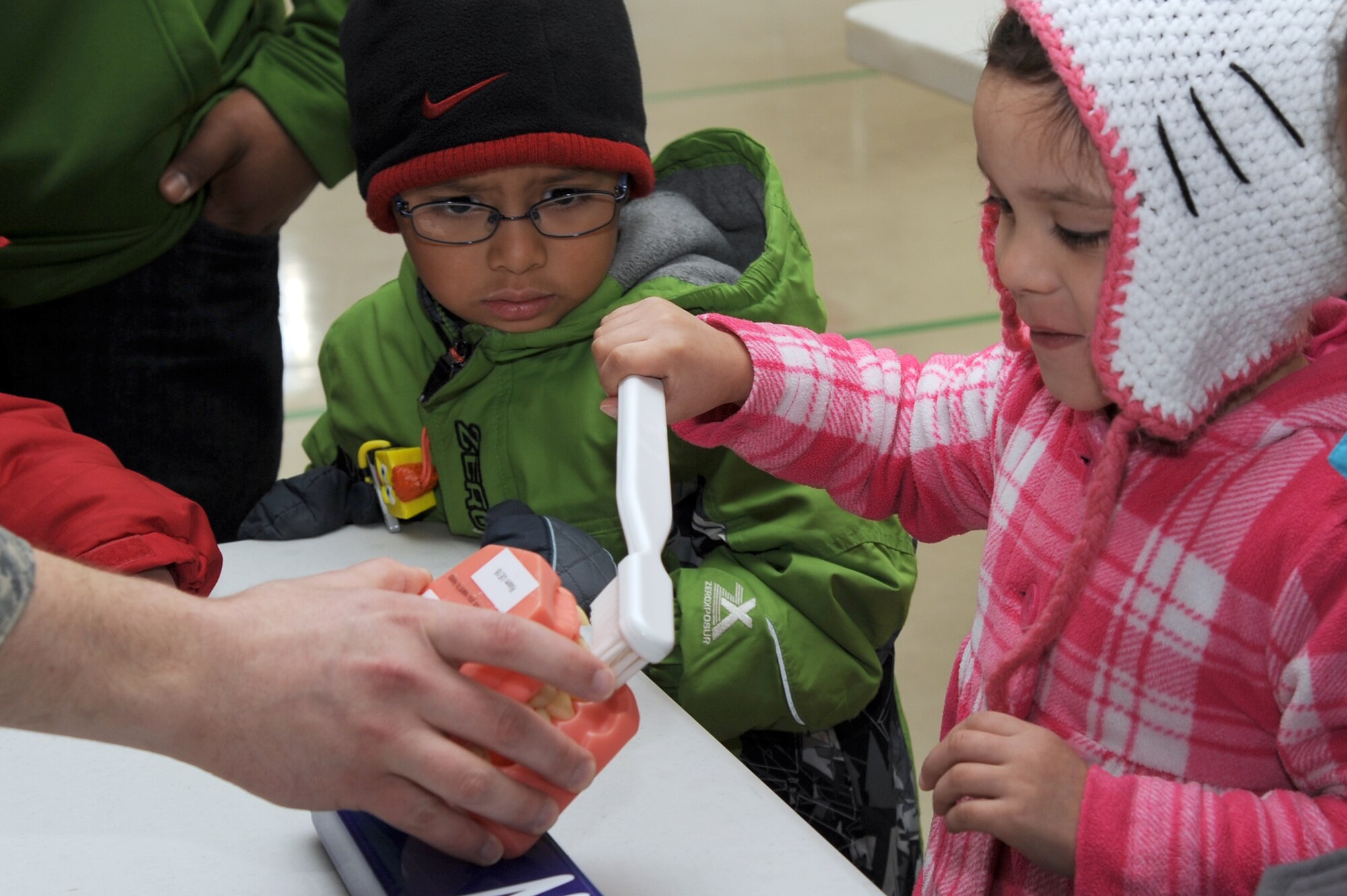 The daughter of U.S. Air Force Staff Sgt. Juan Brambila, 35th Civil Engineer Squadron water fuels maintenance, demonstrates proper brushing techniques during a National Children's Dental Health Month presentation held at Sollars Elementary School on Misawa Air Base, Japan Feb. 16, 2012. National Children's Dental Health Month gives the 35th Dental Squadron the opportunity to teach children about proper oral hygiene and healthy snacking habits. (U.S. Air Force photo by Tech. Sgt. Marie Brown/Released)

