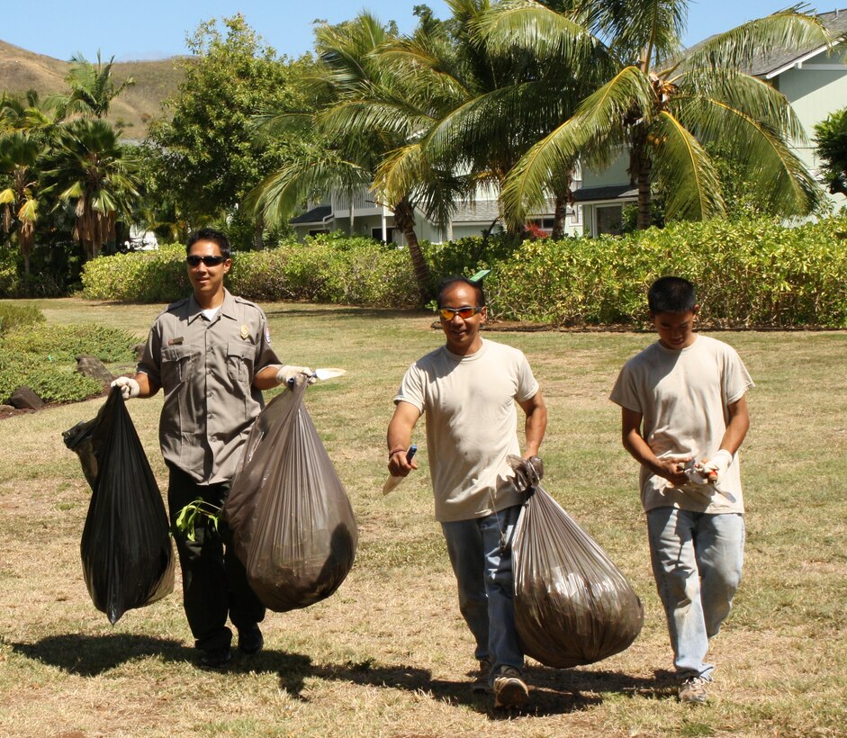 Honolulu District volunteers Park Ranger Corey Yamashita, left, Deputy Chief of Programs and Project Management Steve Cayetano and his son Trent helped clean up Kaha Garden at Kawainui Marsh City Park in Kailua for National Public Lands Day on Saturday, September 24, 2011.