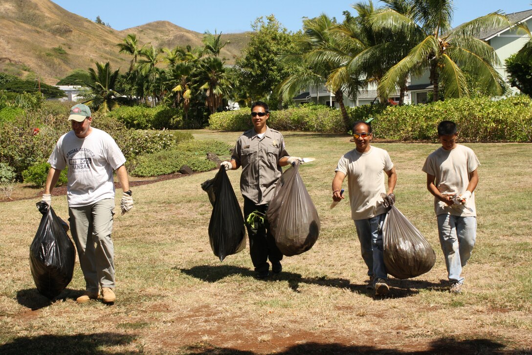 Honolulu District volunteers Commander Lt. Col. Doug Guttormsen, Park Ranger Corey Yamashita, Deputy Chief of Programs and Project Management Steve Cayetano and his son Trent helped clean up Kaha Garden at Kawainui Marsh City Park in Kailua for National Public Lands Day on Saturday, September 24, 2011.