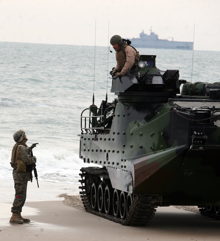 A landing support Marine with Combat Logistics Battalion 26, Combat Logistics Regiment 27, 2nd Marine Logistics Group talks to an armored assault vehicle passenger Feb. 6, 2012, to get an accurate count of vehicles and passengers during exercise Bold Alligator 2012 aboard Camp Lejeune, N.C.  Bold Alligator is a multinational amphibious exercise designed to test the Marine Corps’ readiness by executing a beach assault.  Landing support Marines are responsible for accounting for all gear and personnel on ground and orienting troops toward the fight. 