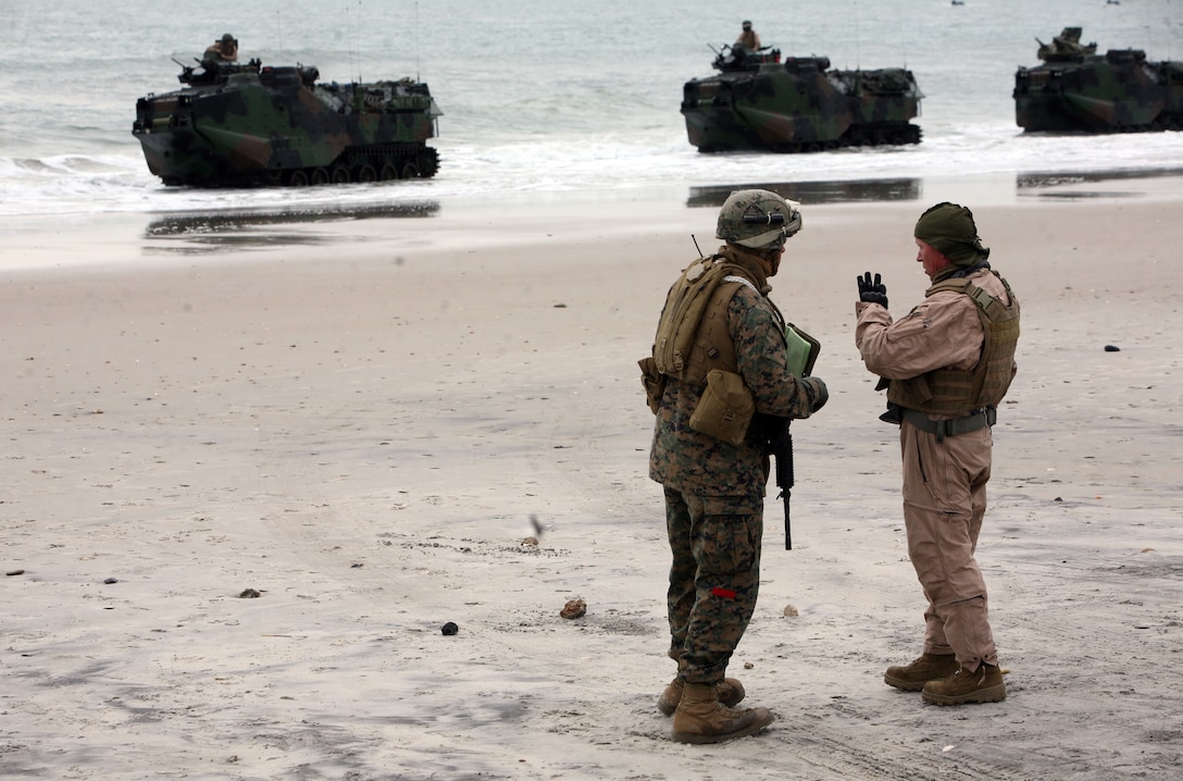 A landing support Marine with Combat Logistics Battalion 26, Combat Logistics Regiment 27, 2nd Marine Logistics Group talks to an armored assault vehicle passenger Feb. 6, 2012, to get an accurate count of vehicles and passengers during exercise Bold Alligator 2012 aboard Camp Lejeune, N.C.  Bold Alligator is a multinational amphibious exercise designed to test the Marine Corps’ readiness by executing a beach assault.  Landing support Marines are responsible for accounting for all gear and personnel on ground and orienting troops toward the fight. 