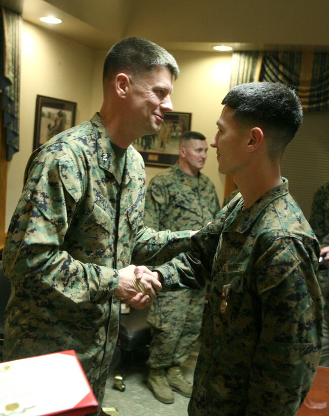 Col. Mark Hollahan, the 2nd Marine Logistics Group commanding officer shakes the hand of Sgt. David A. Steiner, a data network specialist with 2nd MLG from Union Bridge, Md., after awarding him the Navy and Marine Corps Achievement Medal for earning the title of Marine of the Year during a ceremony Jan. 20, 2012, aboard Camp Lejeune, N.C.  Steiner also received an engraved knife as well as a Letter of Appreciation on behalf of the command in recognition for his year-long efforts. (Photo by Cpl. Bruno J. Bego) 