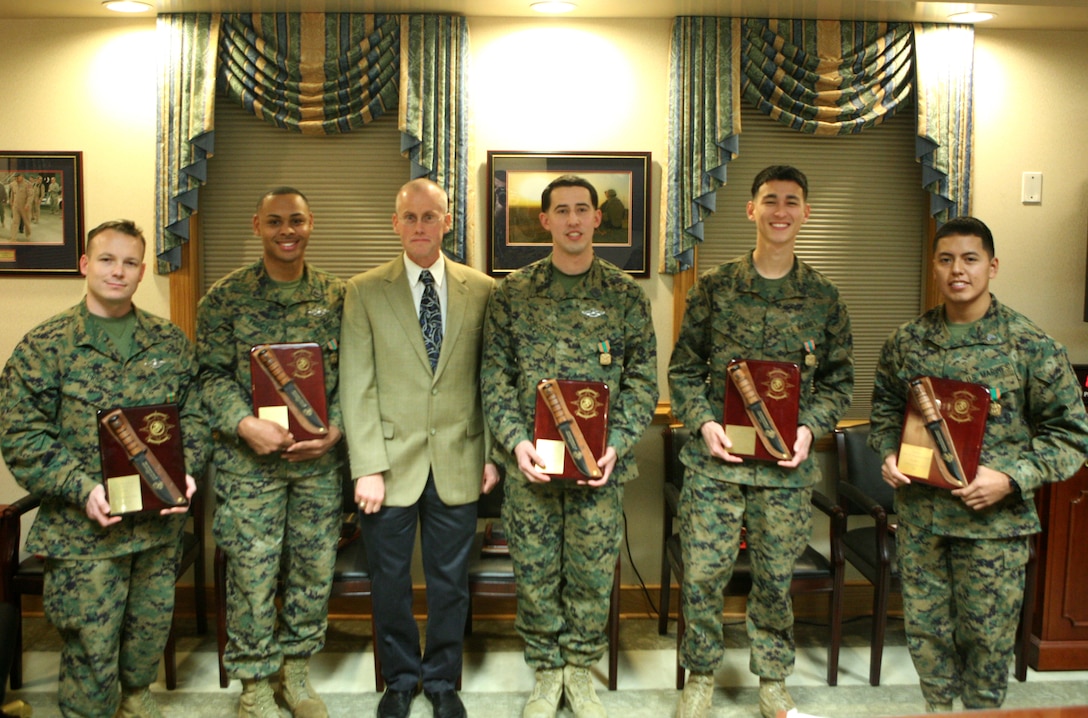 (from left to right) Petty Officer 1st Class Raymond R. Price, from Tarrant County, Texas, Petty Officer 2nd Class Donnell Proctor, from Baltimore, Kevin Jenkins, from Elmira, N.Y., the operations manager from a local business, Seaman Joseph R. Morgott, from New Orleans, Sgt. David A. Steiner, from Union Bridge, Md., and Cpl. Paul W. Vandewettering, from Kaukauna, Wis., pose for a picture Jan. 20, 2012, aboard Camp Lejeune, N.C.  The Marines and sailors each received the Navy and Marine Corps Achievement Medal, an engraved knife and a Letter of Appreciation on behalf of the command in recognition for their year-long efforts during an annual award ceremony. (Photo by Cpl. Bruno J. Bego.) 