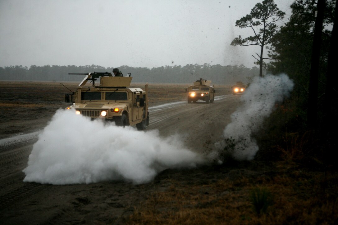 Marines and sailors with 8th Engineer Support Battalion, 2nd Marine Logistics Group conduct convoy operations as a simulated road-side bomb detonates during a Convoy Leaders Course training exercise Jan. 11, 2012, aboard Camp Lejeune, N.C. The Battle Skills Training School offers this training exercise in order to prepare units for upcoming deployments.  The class helps train Marines and sailors to be effective in convoy operations overseas where this knowledge can mean the difference between a successful and unsuccessful mission.