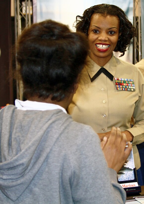 Master Gunnery Sgt. Janel Spencer, Marine Corps Manpower and Reserve Affairs, talks with University High School freshman Katrina Sloan, of Philadelphia, about the challenges and benefits of Marine Corps service. Spencer took part in the Black Engineer of the Year conference Career Fair Expo in Philadelphia Feb. 17-18. She said she hopes students look at her own success and aspire to follow her example.