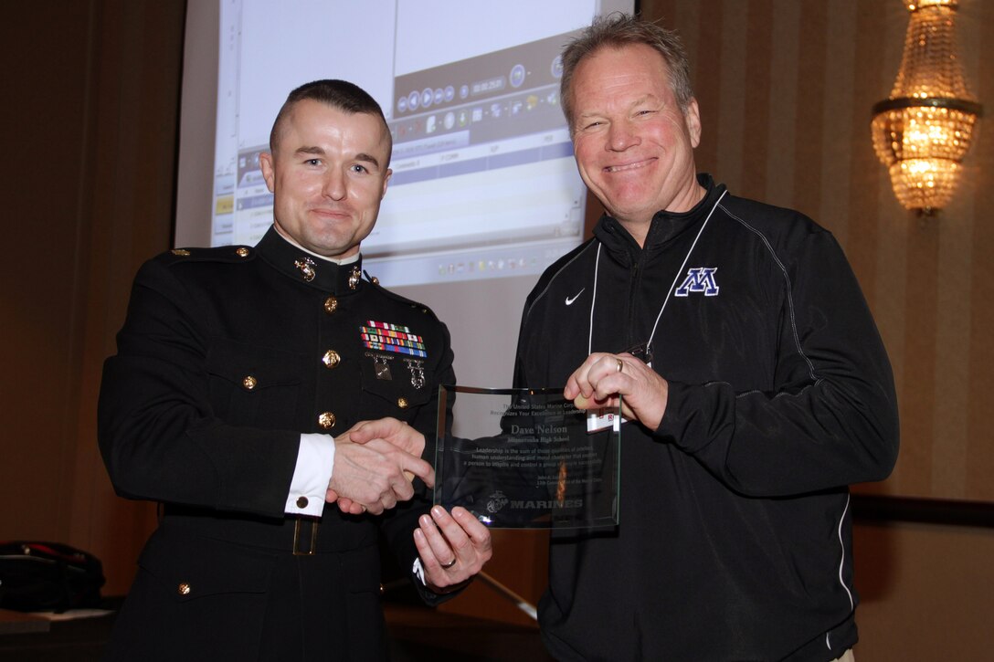 Recruiting Station Twin Cities Commanding Officer Maj. Kenneth Gawronski presents Minnetonka High School football coach Dave Nelson with the Semper Fi Award at the Minneapolis Glazier Clinic Feb 17. The intent behind the Semper Fi Coach Award is to recognize a high school football coach who exemplifies the Marine Corps motto: Semper Fidelis. A Semper Fi Coach is not defined by winning records or championship titles, but rather as a man who creates a legacy of intentional leadership.