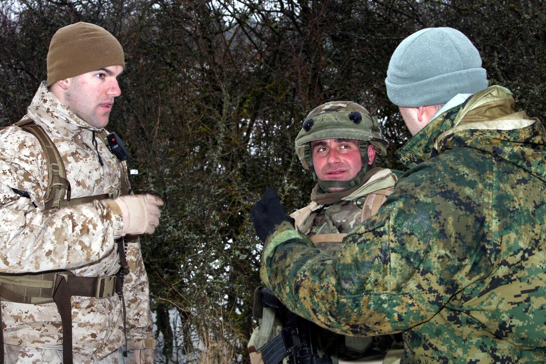 U.S. Marine 2nd Lt. Kevin Kelly, an observer controller for the Georgian 23rd Light Infantry Battalion's mission rehearsal exercise, back briefs one of the leaders for Scout Platoon, Delta Co., after one of the firefights with enemy insurgents. Kelly is a ground intelligence officer at 2nd Marine Division in Camp Lejeune, N.C. He is a native of Potomac, Maryland and a graduate of College of the Holy Cross in Worcester, Mass.