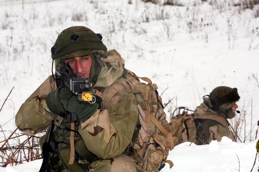 Two Georgian soldiers from Scout Platoon, Delta Co., 23rd Light Infantry Battalion keep a watchful eye on the surrounding area after the platoon engaged in a firefight with enemy insurgents while on a reconnaissance mission during a mission rehearsal exercise at Joint Multinational Readiness Center, Hohenfels, Germany, Feb. 17. The MRE is the culminating event for the Republic of Georgia's 23rd Light Infantry Battalion prior to deploying to Afghanistan to conduct counterinsurgency operations in support of the Georgia Deployment Program - International Security Assistance Force (GDP-ISAF). The total training exercise runs Feb. 1 - 24.