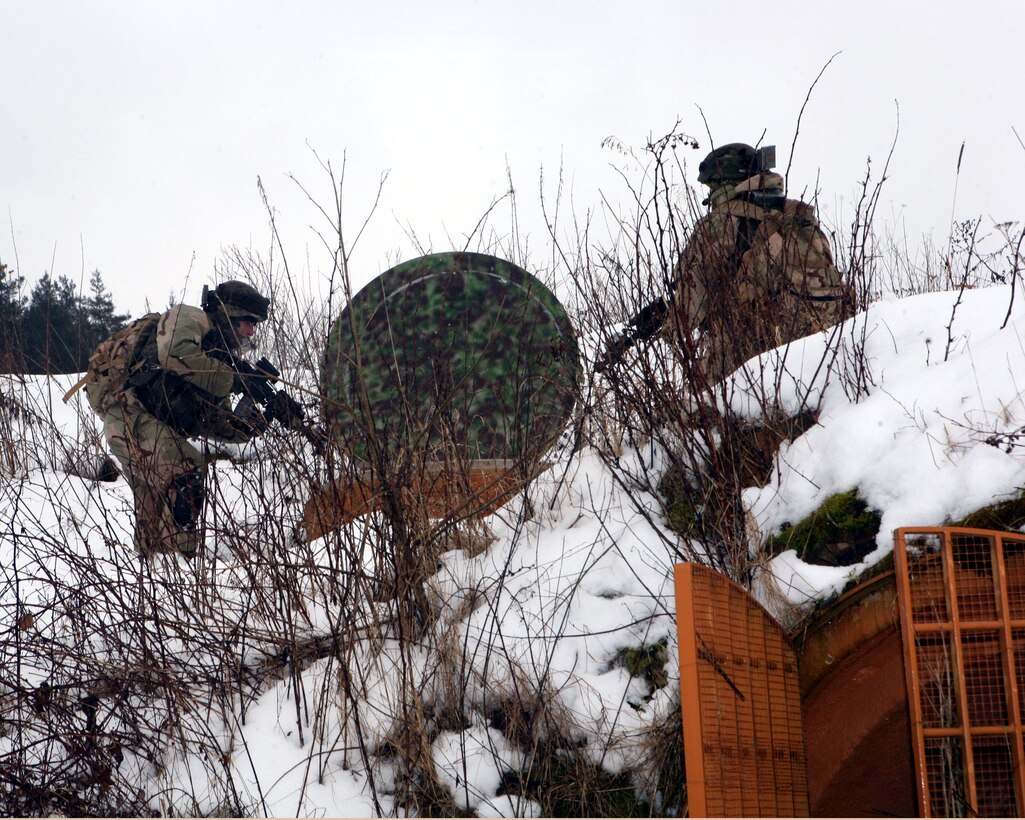 Georgian soldiers from Scout Platoon, Delta Co., 23rd Light Infantry Battalion searches for the enemy who is possibly hiding below in a man-made cave while on a reconnaissance mission during a mission rehearsal exercise at Joint Multinational Readiness Center, Hohenfels, Germany, Feb. 17. The MRE is the culminating event for the Republic of Georgia's 23rd Light Infantry Battalion prior to deploying to Afghanistan to conduct counterinsurgency operations in support of the Georgia Deployment Program - International Security Assistance Force (GDP-ISAF). The total training exercise runs Feb. 1 - 24.