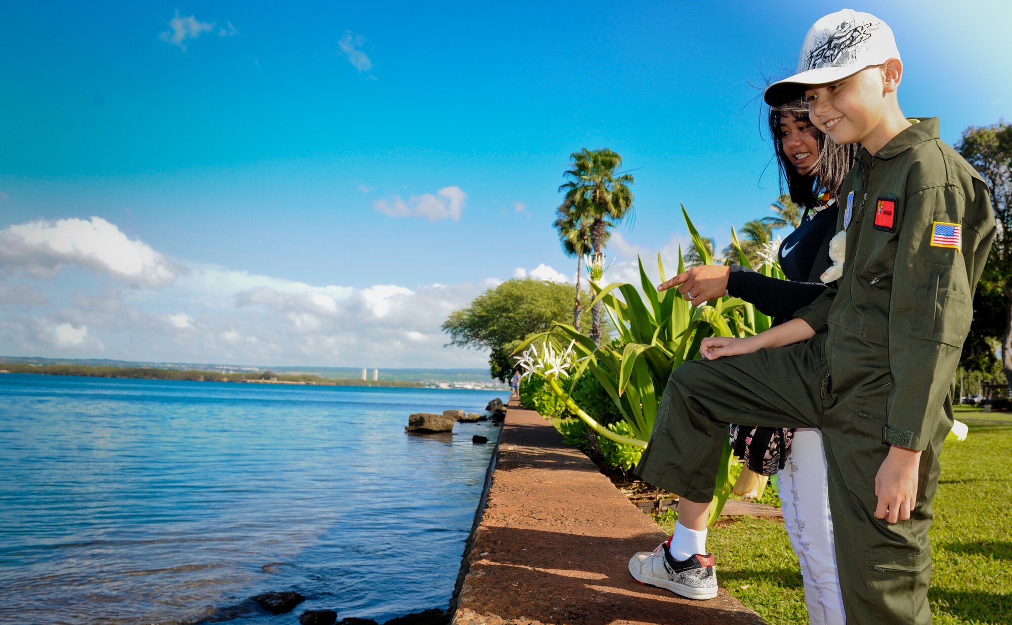Brandon Whedbee, an 11-year-old leukemia patient admires the fish in the channel at the Missing Man Formation memorial Feb. 17 at Joint Base Pearl Harbor-Hickam, Hawaii. The original Pilot for a Day program was created by Captain Rory “Ox” Blackburn at Randolph Air Force Base in December 1994, and has since spread to several bases across the country. (U.S. Air Force photo/Senior Airman Lauren Main)