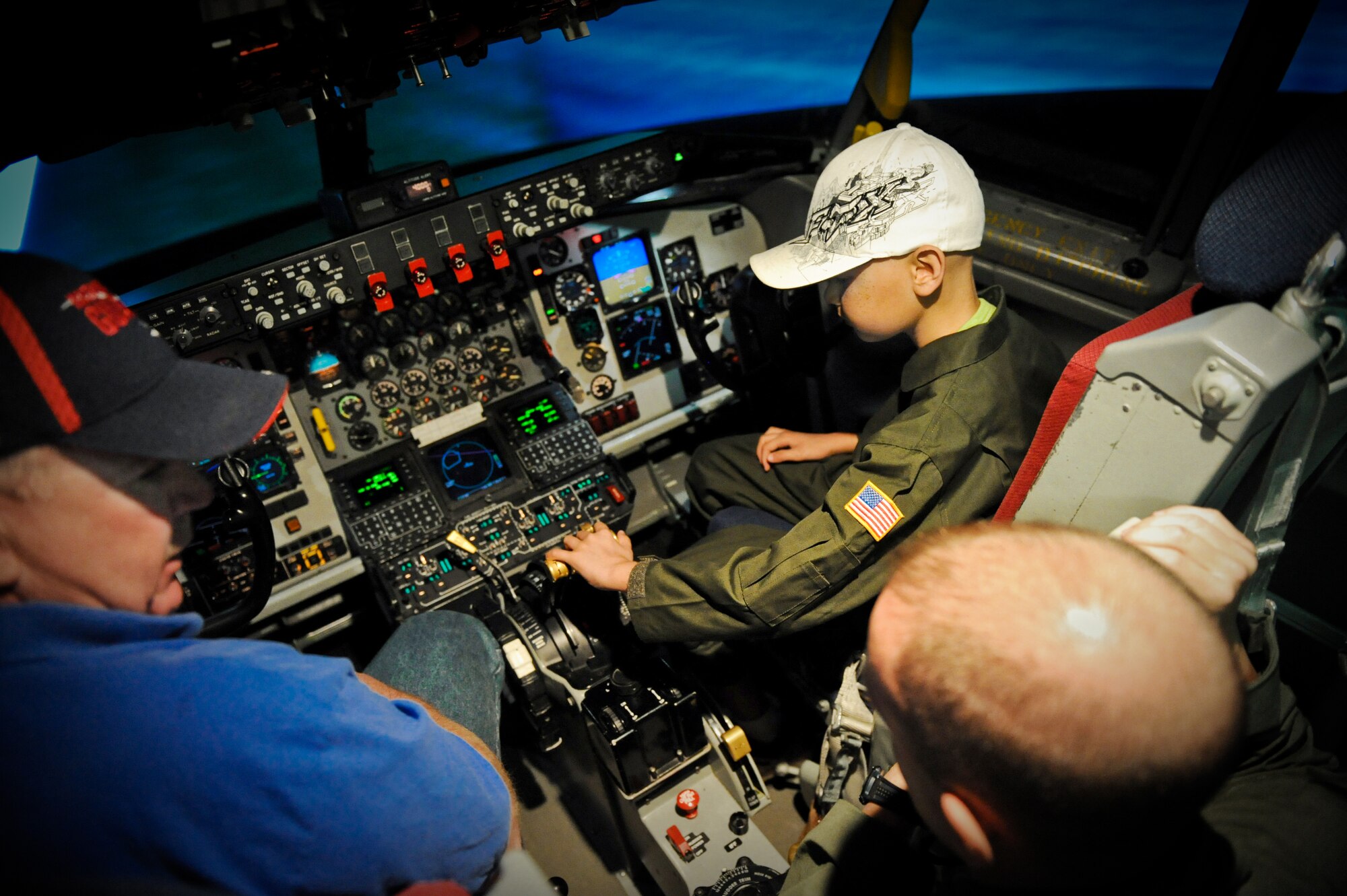 Brandon Whedbee, an 11-year-old leukemia patient plays with the controls of the KC-135 Stratotanker simulator Feb. 17 on Joint Base Pearl Harbor-Hickam, Hawaii. The goal of the Pilot for a Day program is to benefit children and their families in the local community who have terminal illnesses. (U.S. Air Force photo/Senior Airman Lauren Main)