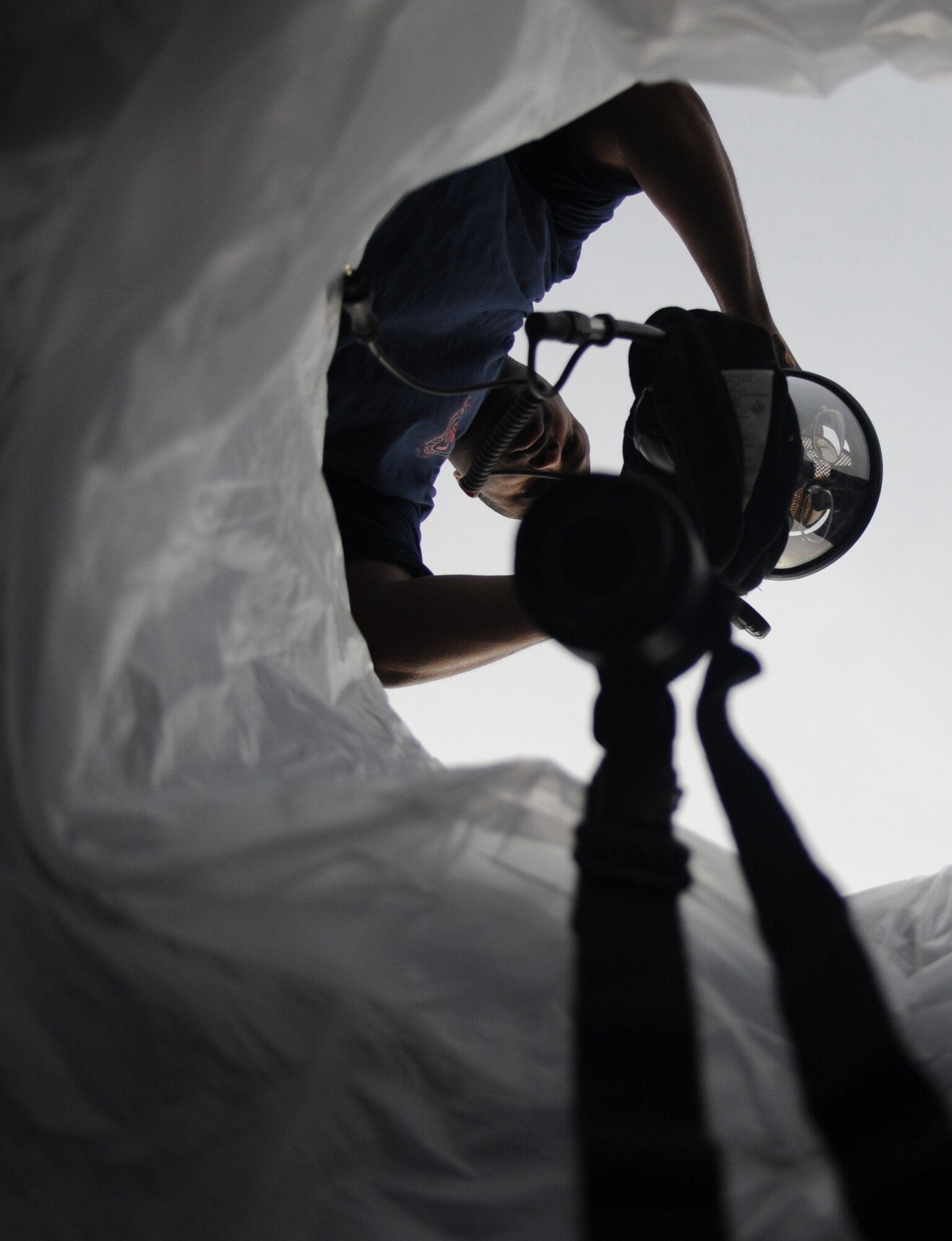 A firefighter from the 2nd Civil Engineer Squadron places his mask in a decontamination storage unit on Barksdale Air Force Base, La., Feb. 16. In order to avoid further contamination, members must remove all affected equipment and clothing when processing through a decontamination zone. (U.S. Air Force photo/Airman 1st Class Micaiah Anthony)(RELEASED)