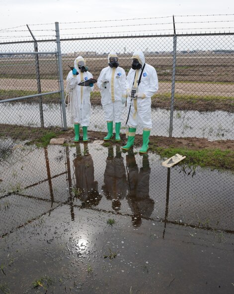 Airmen from the 2nd Civil Engineer Squadron conduct a simulated contamination sweep on Barksdale Air Force Base, La., Feb. 16. Once a sweep is made and the area is clear, a decontamination zone is setup. (U.S. Air Force photo/Airman 1st Class Micaiah Anthony)(RELEASED)