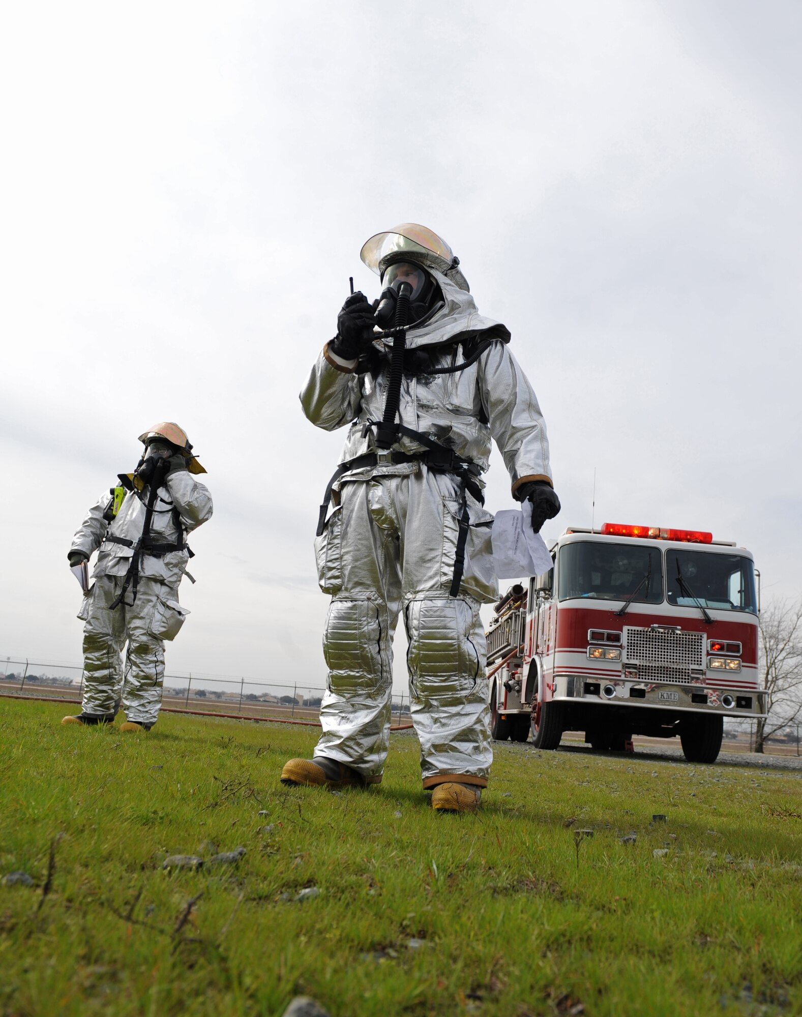Firefighters from the 2nd Civil Engineer Squadron use a radio to communicate with other emergency personnel on Barksdale Air Force Base, La., Feb. 16. Firefighters, bomb disposal technicians and other emergency management personnel responded to a simulated downed aircraft carrying weapons. (U.S. Air Force photo/Airman 1st Class Micaiah Anthony)(RELEASED)