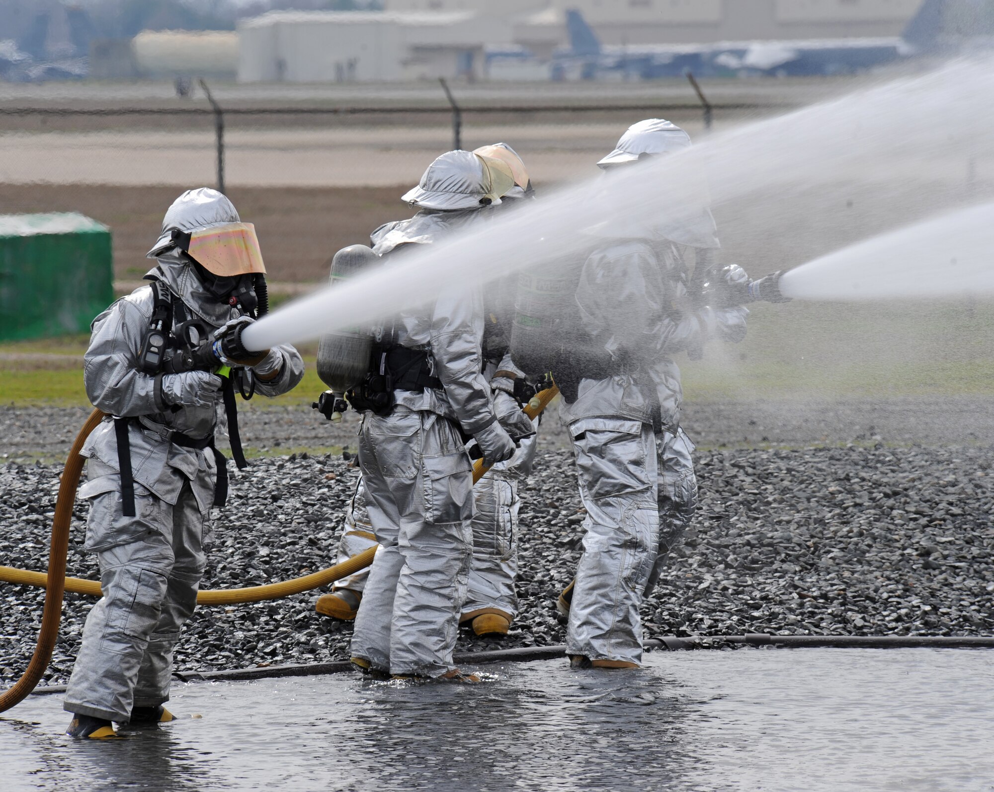 Firefighters from the 2nd Civil Engineer Squadron douse a mock aircraft with water on Barksdale Air Force Base, La., Feb. 16. The mock aircraft was set on fire to simulate a downed aircraft carrying a nuclear weapon. Firefighters have to work quickly to extinguish flames in scenarios involving armaments to prevent collateral damage. (U.S. Air Force photo/Airman 1st Class Micaiah Anthony)(RELEASED)