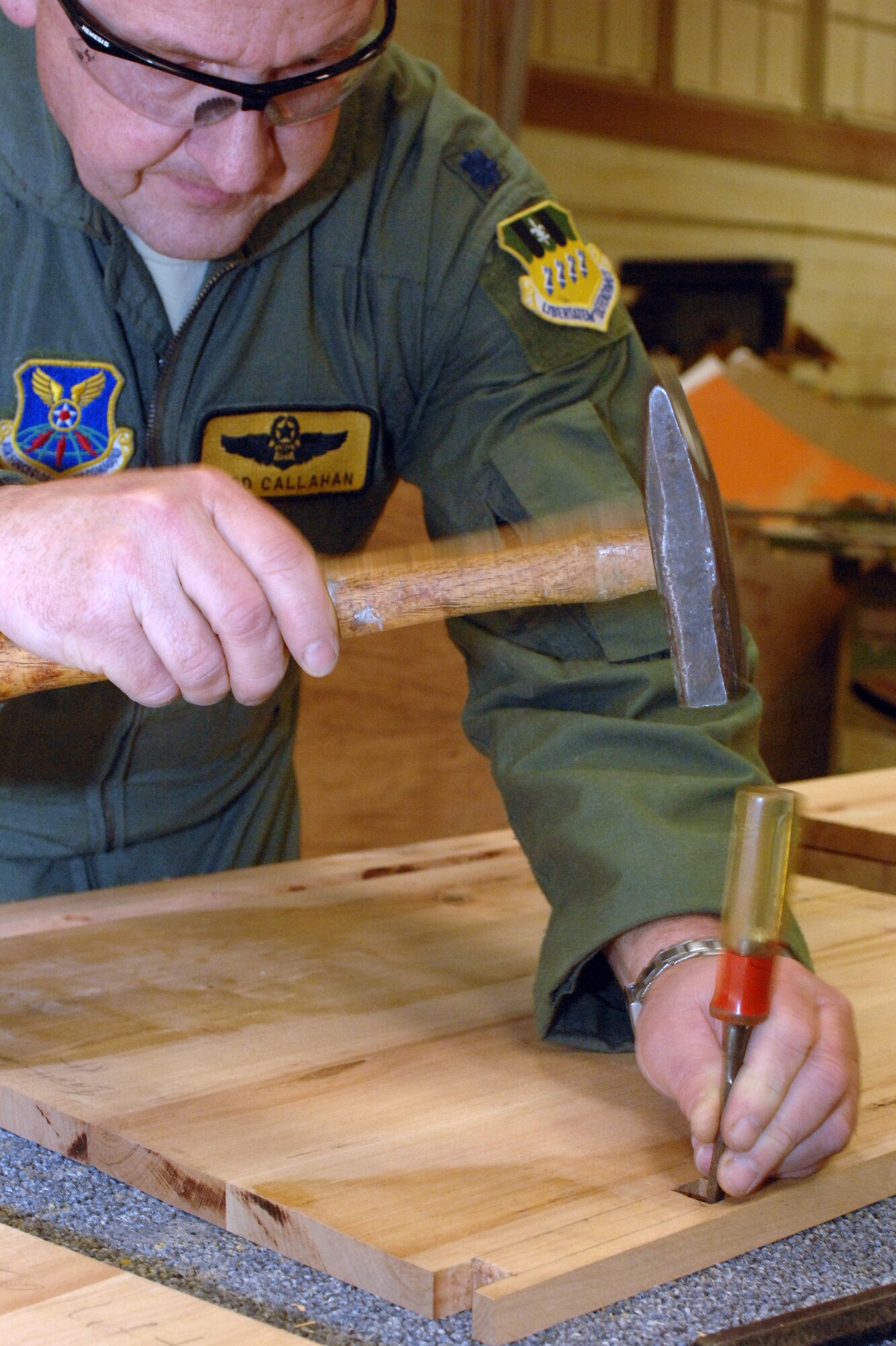 Lt. Col. Todd Callahan, 11th Bomb Squadron Training Flight assistant director of operations, chisels away a square hole inside the Hobby Shop on Barksdale Air Force Base, La., Feb. 15. Callahan refurbished an old dresser that was in his home. (U.S. Air Force photo/Airman 1st Class Joseph A. Pagán Jr.)(RELEASED)
