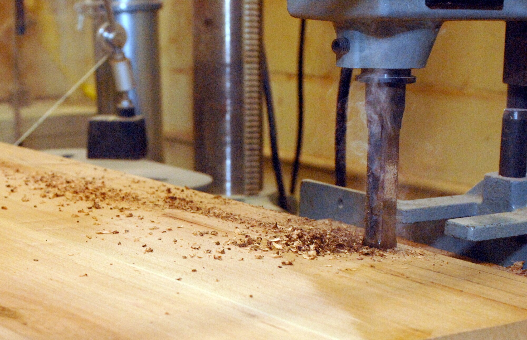 A drill press is used to make a square hole inside the Hobby Shop on Barksdale Air Force Base, La., Feb. 15. The shop has a large selection of wood and machines which can be used to make any project desired. (U.S. Air Force photo/Airman 1st Class Joseph A. Pagán Jr.)(RELEASED)
