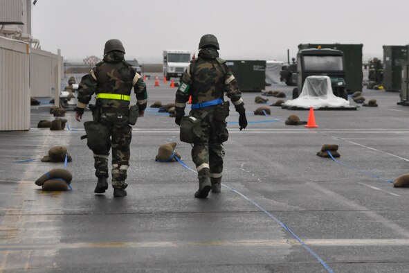 Airmen assigned to the 62nd Airlift Wing walk to their work areas during a mobility exercise Feb. 17, 2012, at Joint Base Lewis-McChord, Wash. (U.S. Air Force photo/Airman 1st Class Leah Young)