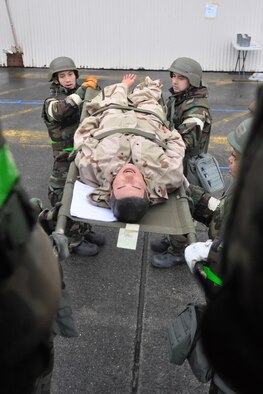 Airmen assigned to the 446th Aeromedical Staging Squadron load a simulated patient onto a medical bus during a mobility exercise Feb. 17, 2012, at Joint Base Lewis-McChord, Wash. (U.S. Air Force photo/Airman 1st Class Leah Young) 