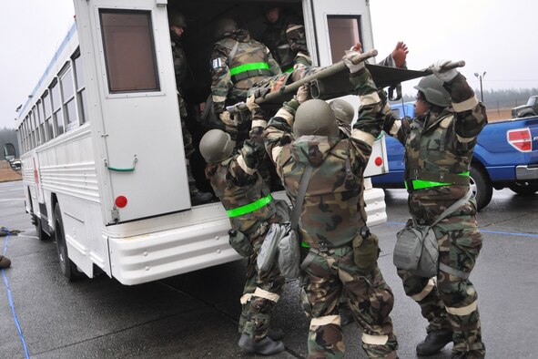 Airmen assigned to the 446th Aeromedical Staging Squadron load a simulated patient onto a medical bus during a mobility exercise Feb. 17, 2012, at Joint Base Lewis-McChord, Wash. The team had to demonstrate the ability to transport patients from a deployed environment to a larger medical facility. (U.S. Air Force photo/Airman 1st Class Leah Young)