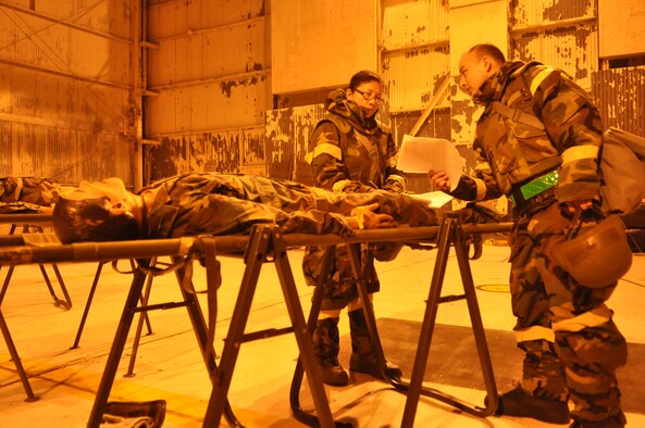 Airmen assigned to the 446th Aeromedical Staging Squadron assess a simulated patient’s injuries during a mobility exercise Feb. 17, 2012, at Joint Base Lewis-McChord, Wash. This exercise marked the first opportunity for the 62nd and 446th AWs and 627th ABG to train together in preparation for the 2012 operational readiness inspection. (U.S. Air Force photo/Airman 1st Class Leah Young)
