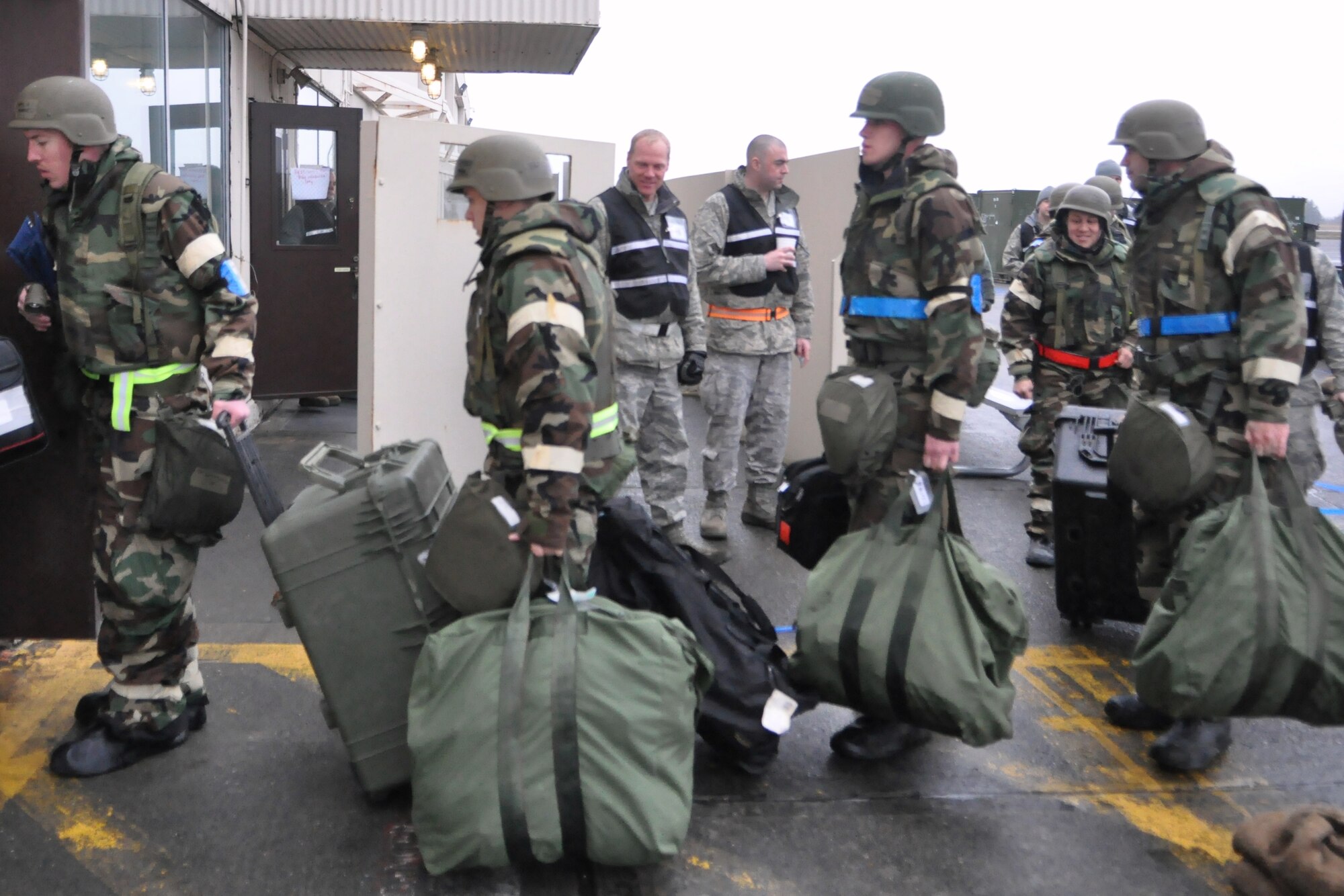 Airmen assigned to the 62nd and 446th Airlift Wings and 627th Air Base Group take equipment to work areas during a mobility exercise Feb. 17, 2012, at Joint Base Lewis-McChord, Wash. The exercise was conducted to improve the ability to survive and operate, solidify mobility processes and strengthen the ability to complete missions under adversity in preparation for the Operational Readiness Inspection in October. (U.S. Air Force photo/Airman 1st Class Leah Young)