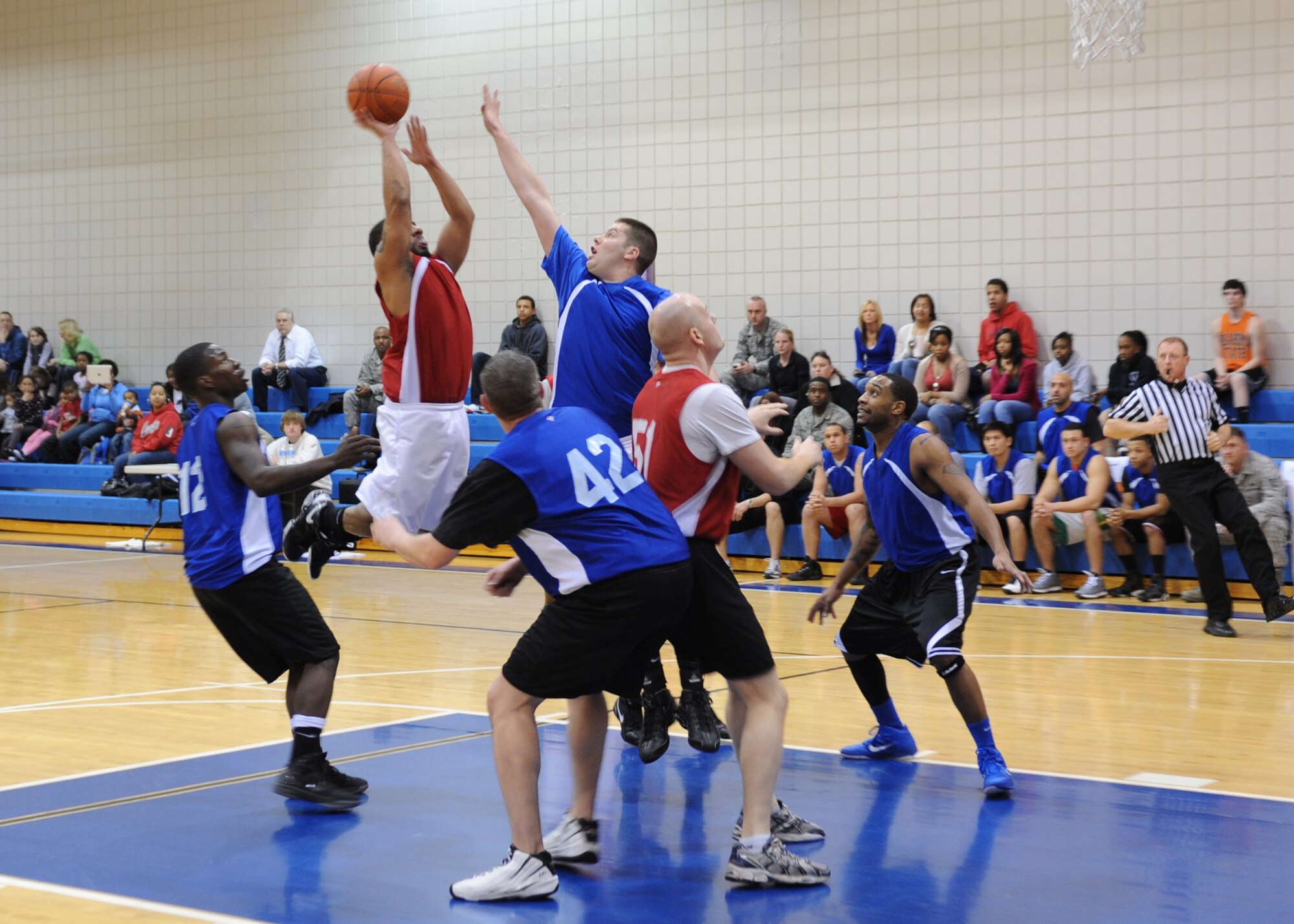 A member of the 22nd Contracting Squadron/ Director of Staff intramural basketball team attempts to make a shot during the Intramural Basketball Championship game against the 22nd Security Forces Squadron Feb. 16, 2012, McConnell Air Force Base, Kan. Security forces won the game 34-32, and completed the season undefeated. (U.S. Air Force photo/ Airman 1st Class Maurice Hodges)