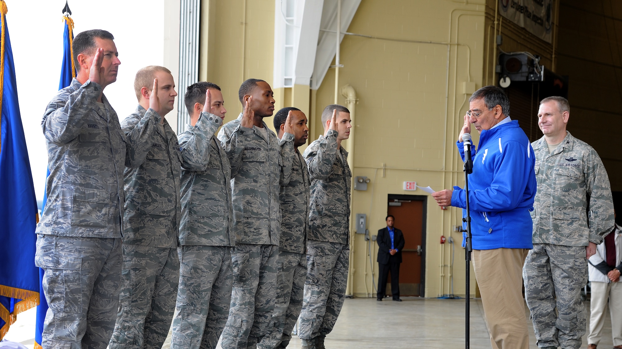 BARKSDALE AIR FORCE BASE, La. -- Secretary of Defense Leon Panetta reenlists six Airmen at Barksdale Air Force Base, La. Feb. 17.  During his visit to the base Panetta also presented medals and coins, held a town hall meeting and met with Headquarters Air Force Global Strike Command for briefings on global strike capabilities.  (U.S. Air Force Photo/Master Sgt. Corey A. Clements)(Released)
