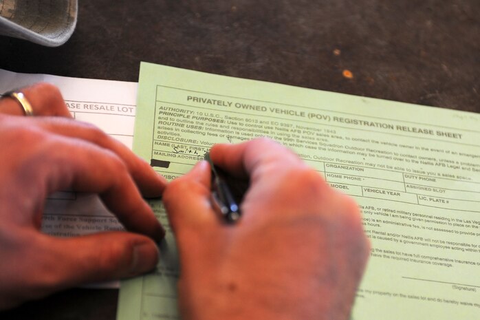 A Nellis Air Force Base resident applies for a permit to display a vehicle in the Nellis Resale lot. Residents must have a valid permit from the Nellis Auto Hobby shop and may only display the vehicle  for specific periods of time at the Nellis Resale Lot. (U.S. Air Force photo by Senior Airman Jack Sanders)