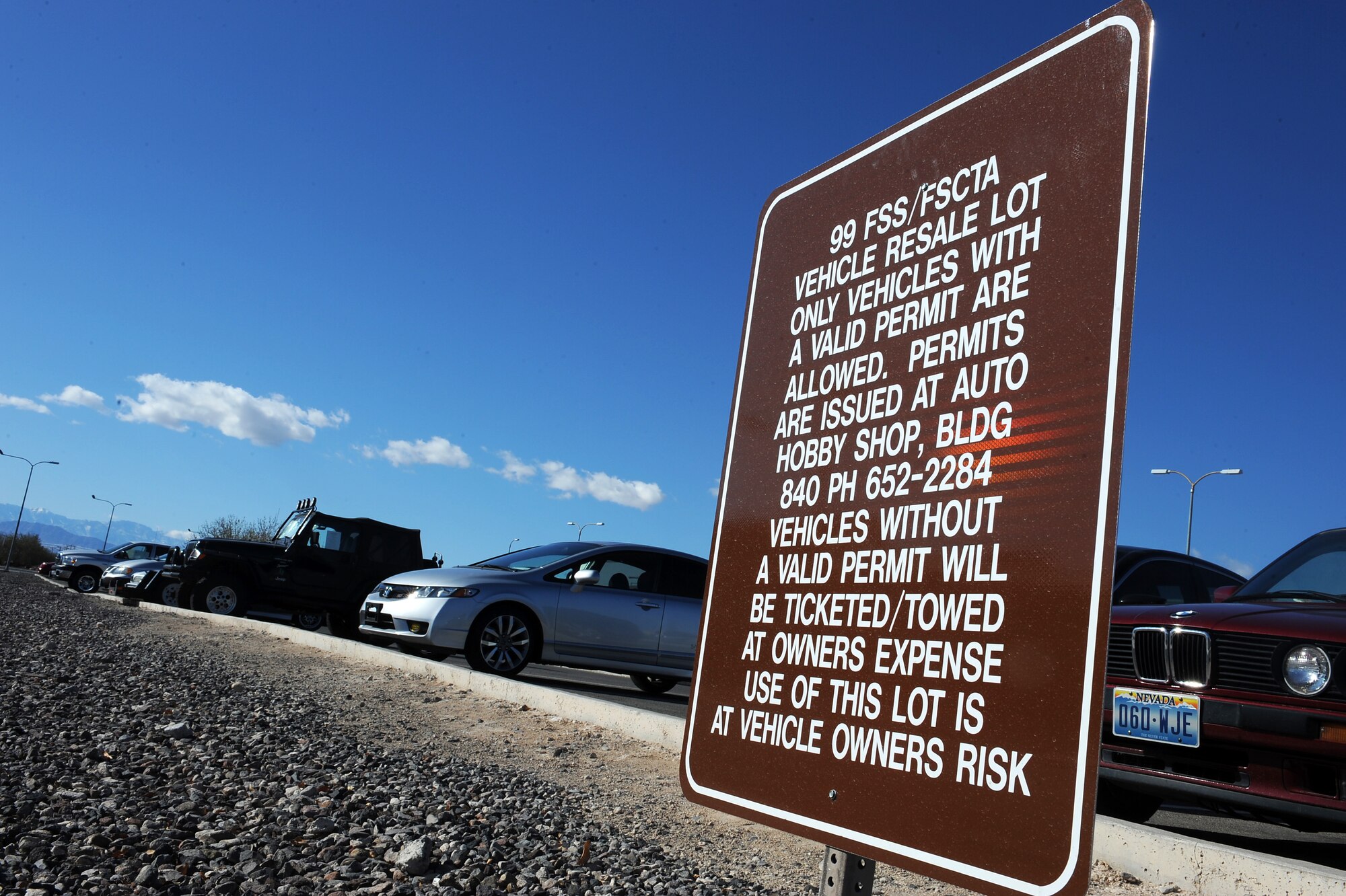 Nellis Air Force Base Resale lot signs advise motorist, vehicles parked in the lot without the proper permit may be towed at the owners expense. Parking lots on base are intended for daily-use by workers and guests, but some vehicles have been left for extended periods of time causing a parking issue. (U.S. Air Force photo by Senior Airman Jack Sanders)