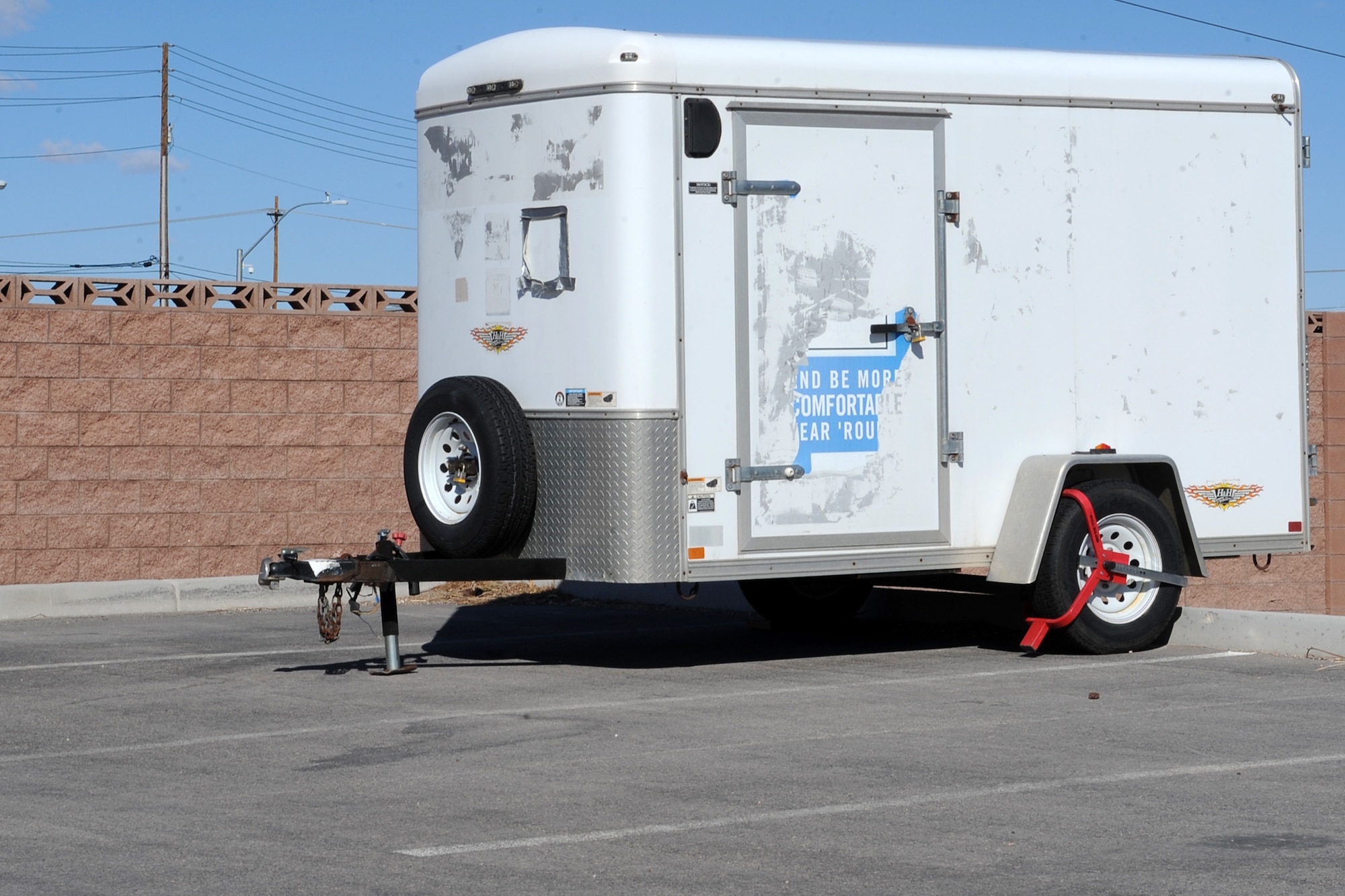 99th Security Forces Squadron booted this trailer, which is seen parked in a unauthorized parking space here Feb. 16th, 2012 at Nellis Air Force Base, Nev. Security Forces will tow (at the owner's expense), impound, and possibly dispose of any vehicles or recreational equipment that are improperly parked or abandoned. (U.S. Air Force photo by Senior Airman Jack Sanders)