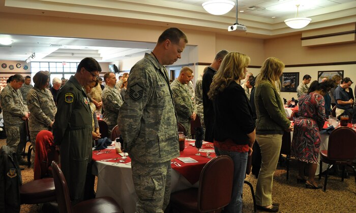Members of Team Beale bow in prayer during the National Prayer Luncheon at the Recce Point Club at Beale Air Force Base Calif., Feb. 16, 2012. The Luncheon was put on by the base chapel staff to promote unity between all faiths. (U.S. Air Force photo by Staff Sgt. Robert M. Trujillo/Released)