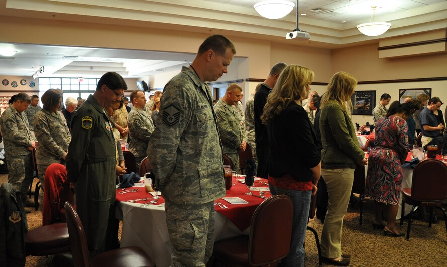 Members of Team Beale bow in prayer during the National Prayer Luncheon at the Recce Point Club at Beale Air Force Base Calif., Feb. 16, 2012. The Luncheon was put on by the base chapel staff to promote unity between all faiths. (U.S. Air Force photo by Staff Sgt. Robert M. Trujillo/Released)