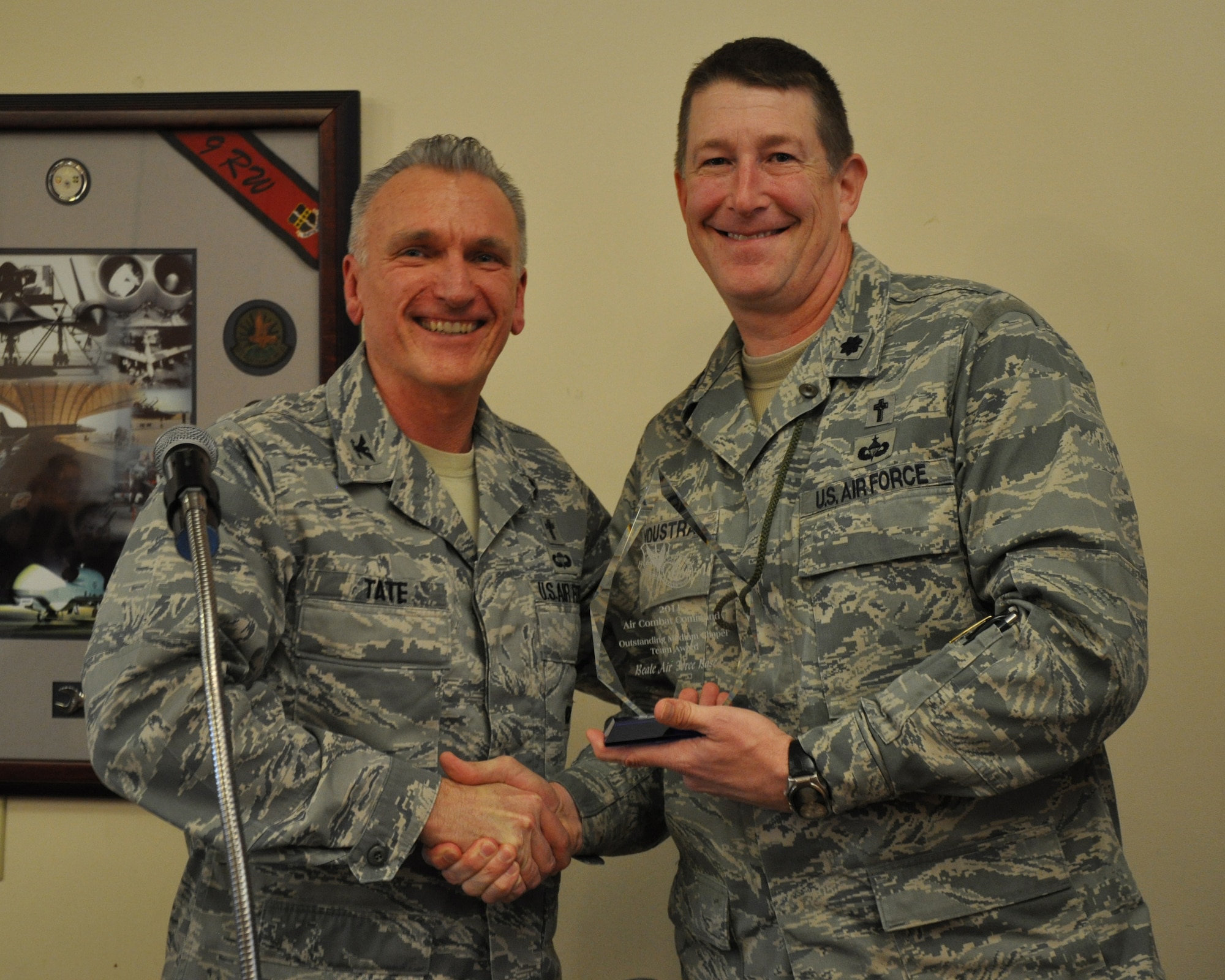 Chaplain (Col.) Gregory L. Tate, Command Chaplain for Air Combat Command, presents Chaplain (Lt. Col.) George T. Youstra, 9th Reconnaissance Wing, with the 2011 ACC Outstanding Medium Chapel Team Award at the National Prayer Luncheon at Beale Air Force Base Calif., Feb. 16, 2012. Chaplain Tate was the guest speaker at the luncheon and was on hand to present the ACC level award to Beale. (U.S. Air Force photo by Staff Sgt. Robert M. Trujillo/Released)