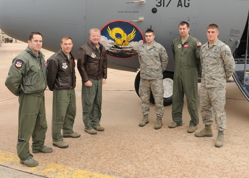 The crew of a new C-130 J-model gathers outside the aircraft Feb. 16, 2011, at Dyess Air Force Base, Texas. The aircraft is the 15th of 28 to be delivered to Dyess by 2013, replacing the current aging fleet of the C-130 Hercules. (U.S. Air Force photo by Airman 1st Class Peter Thompson/Released)