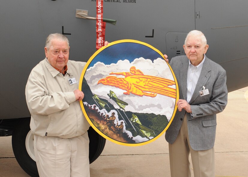 Retired Col. Russel Klinginsmith, left, and retired Lt. Col. Al Miller, right, pose with a nose art decal which will be painted on the front of the newest C-130 J delivered to Dyess February 16, 2012, at Dyess Air Force Base, Texas. The aircraft is 15th of 28 J-models to be delivered to Dyess by 2013. (U.S. Air Force photo by Airman 1st Class Peter Thompson/Released)
