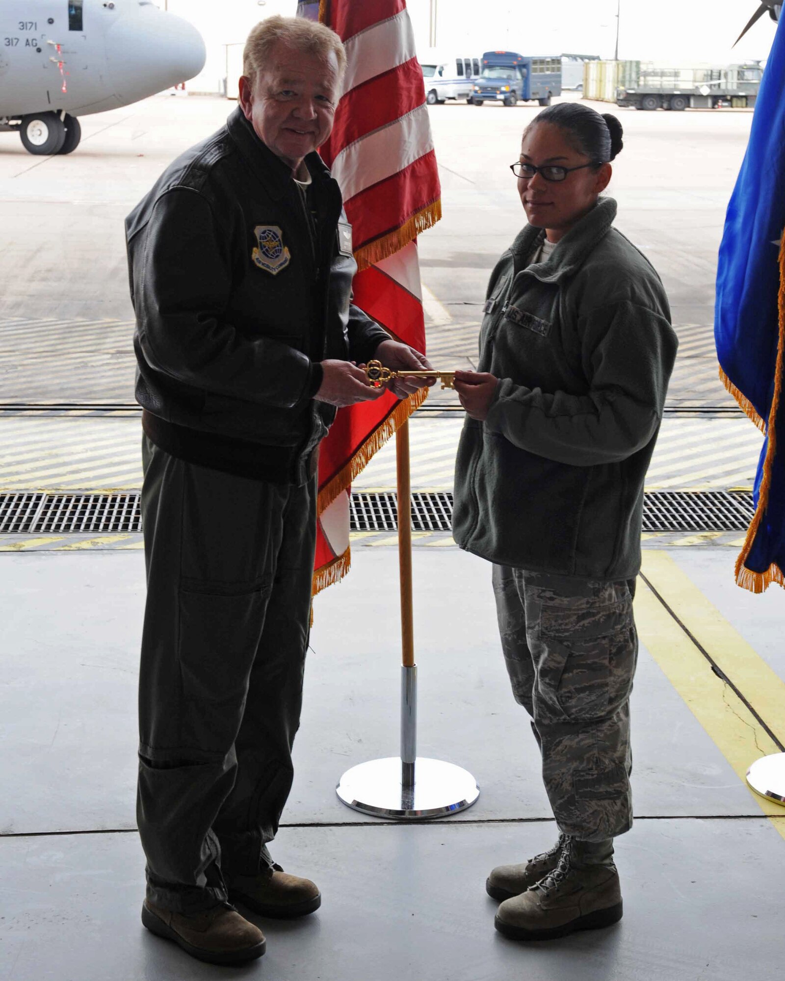 Maj. Gen. Charles Reed Jr., Air Force Reserve Command, presents the honorary key to Airman 1st Class Diandra Pena, 317th Aircraft Maintenance Squadron February 16, 2012, at Dyess Air Force Base, Texas. The aircraft is 15th of 28 J-models to be delivered to Dyess by 2013, replacing the current aging fleet of the C-130 Hercules.  (U.S. Air Force photo by Airman 1st Class Peter Thompson/Released)