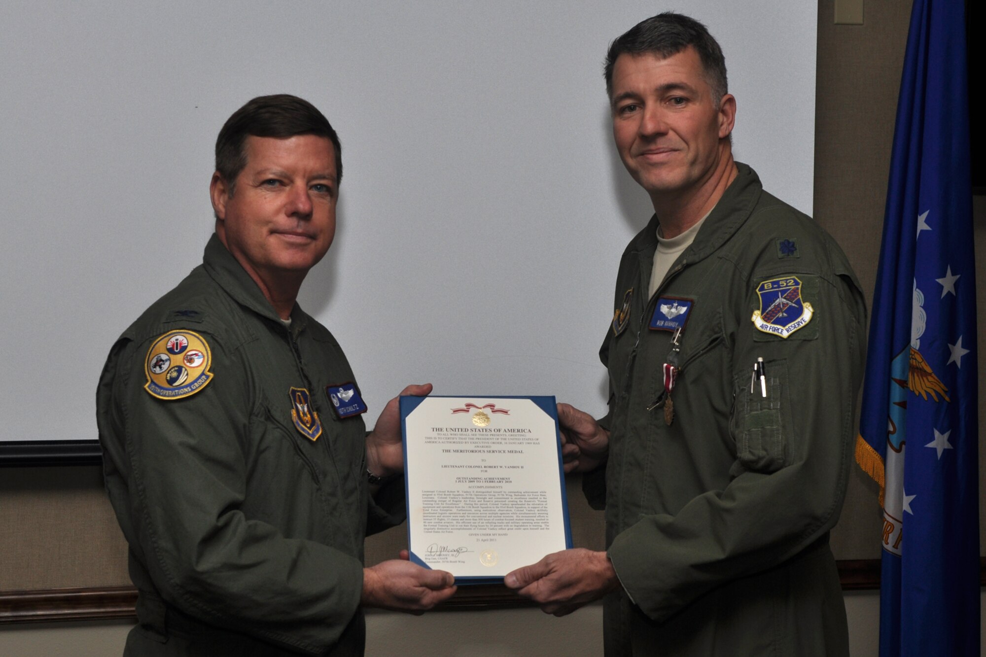 Col. Keith Schultz, commander of the 307th Operations Group, poses for a photo after presenting The Meritorious Service Medal to Lt. Col. Robert W. Vanhoy II, director of scheduling for the 93rd Bomb Squadron, during the 307th Operations Group Commander’s Call at the 93rd BS building on Barksdale Air Force Base, La., Feb. 17, 2012. (U.S. Air Force photo by Master Sgt. Jeff Walston)