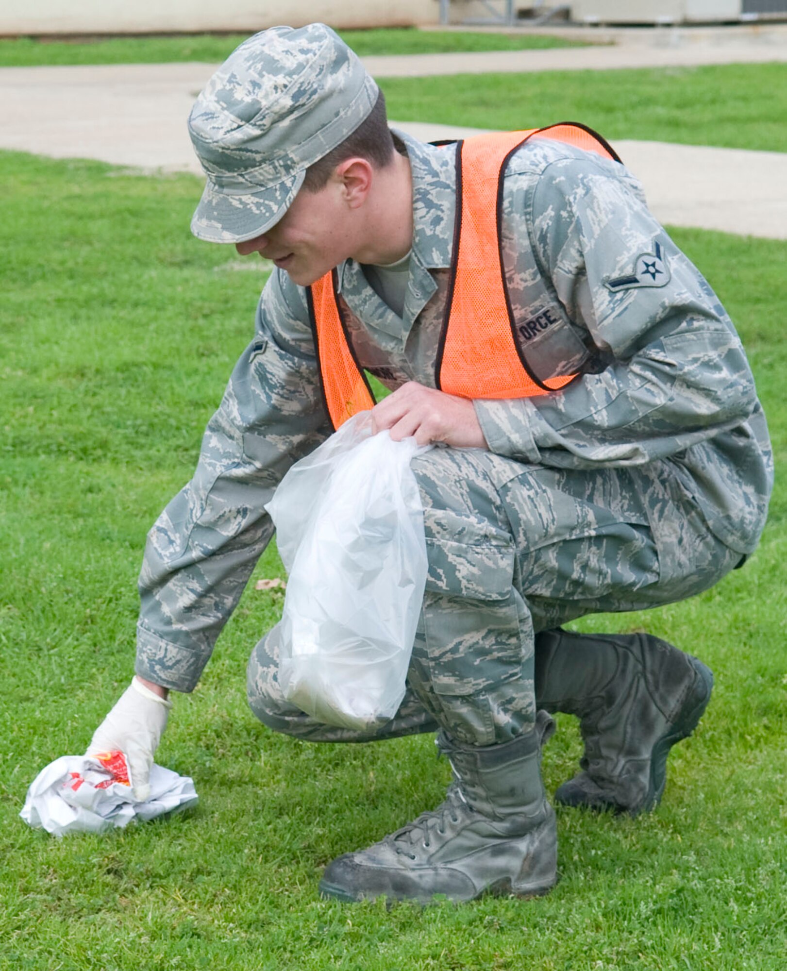 Airman Jonathan Dinsmore, 2nd Maintenance Squadron, picks up trash around the dorms during bay orderly duty on Barksdale Air Force Base, La., Feb. 17. Bay orderly Airmen are assigned to help clean and maintain the dorm laundry rooms, day rooms and perimeters of the dorm buildings. (U.S. Air Force photo/Senior Airman Kristin High)(RELEASED)