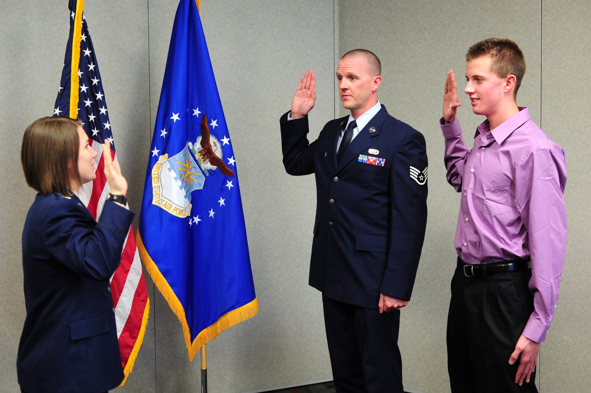 Brenden Jacobs Jones, 17 years old, a senior at Chatfield High School in Littleton, Colo., enlisted for six years at the same time his father, Staff Sgt. Conrad Jones, 310th Force Support Squadron Unit Training Manager, extended his current enlistment to 6 more years, February 13. The enlisted oath was administered in the ARPC conference room by 1st Lt. April C. Harker, 310th Force Support Squadron Acting Operations Officer.
