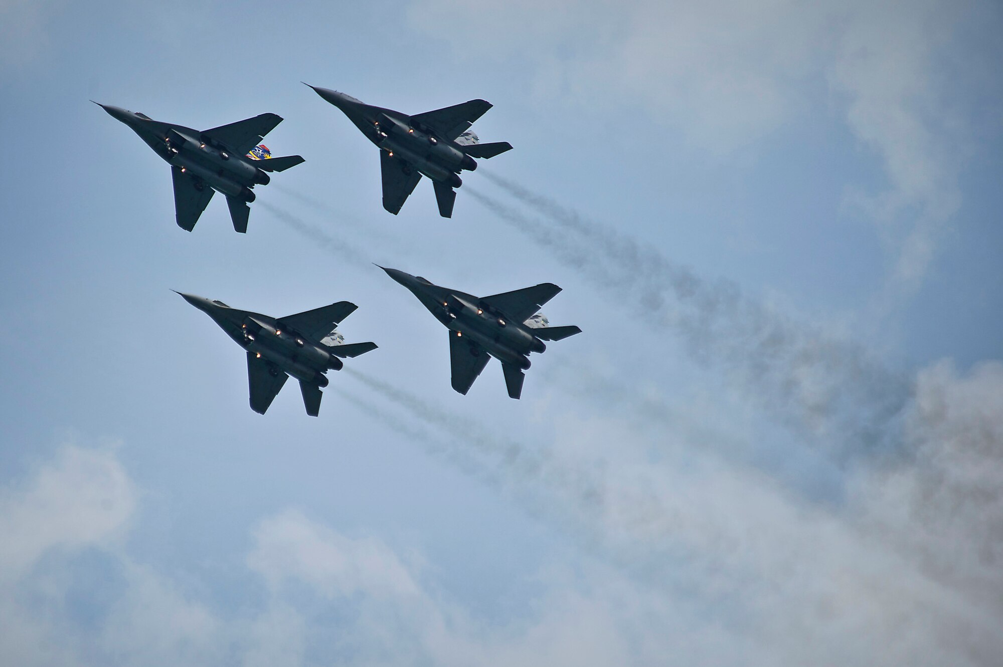 CHANGI, SINGAPORE -- A four ship of MiG-29 aircraft from the Royal Malaysian Air Force(RMAF) aerobatic display team the "Smokey Bandits" perform during the 2012 Singapore Airshow on Feb. 15. The RMAF feature the worlds only female MiG-29 pilot, Maj. Patricia Yapp Syau Yin. (Department of Defense photo by U.S. Air Force Tech. Sgt. Michael R. Holzworth/Released)